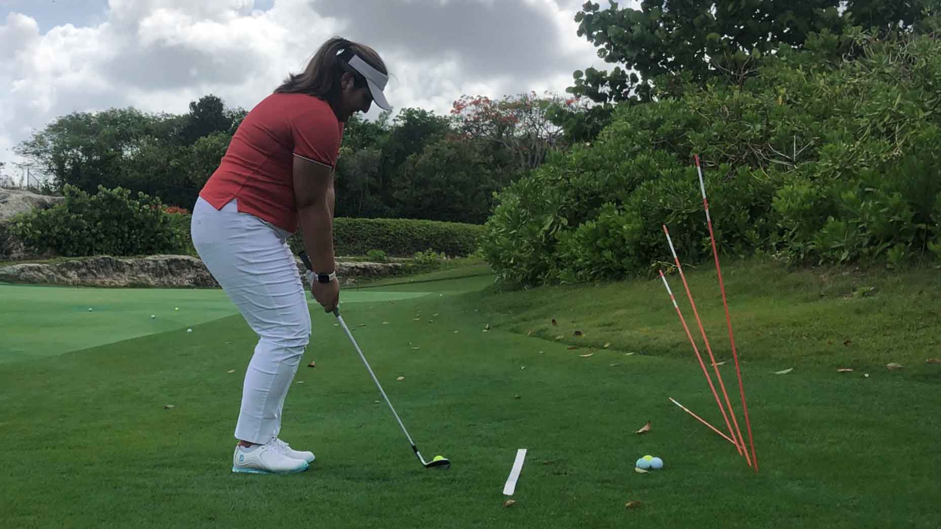 a player uses alignment sticks to practice different trajectories