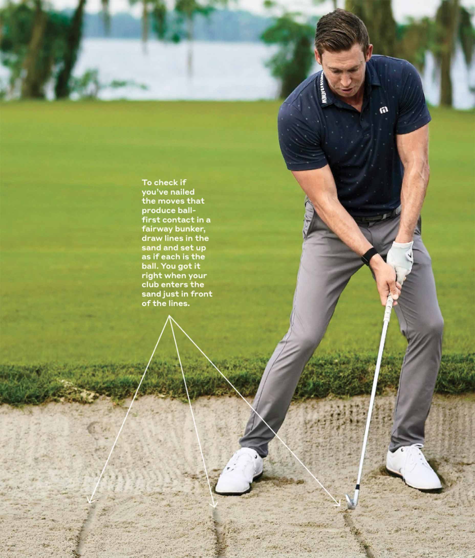 A man hits out of a fairway bunker