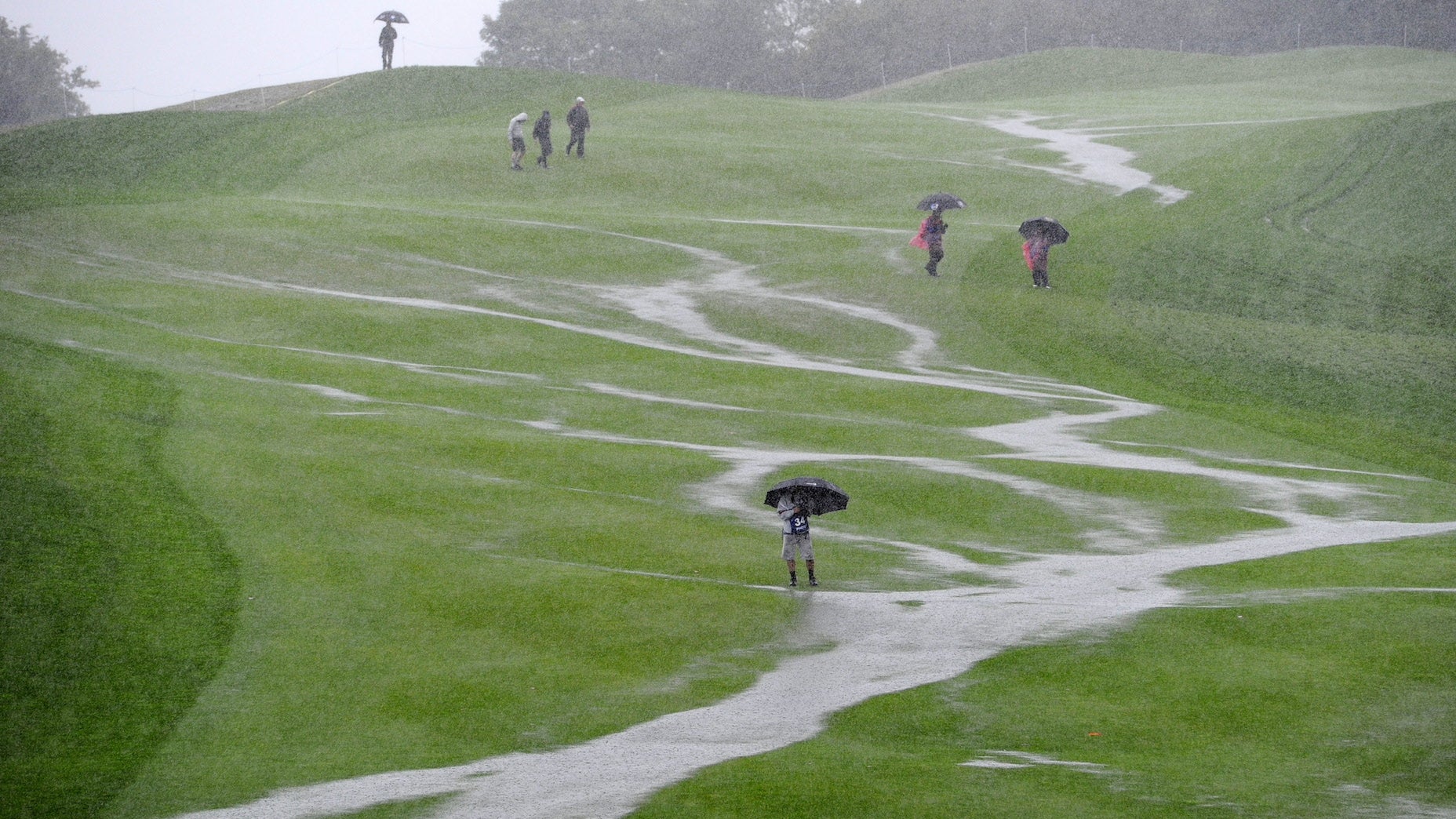 The flooded 18th fairway is pictured after heavy rainfall during the opening fourball round on the first day of the 2010 Ryder Cup golf competition between US and Europe at Celtic Manor golf course in Newport, Wales on October 1, 2010. AFP PHOTO/GLYN KIRK (Photo credit should read GLYN KIRK/AFP via Getty Images)