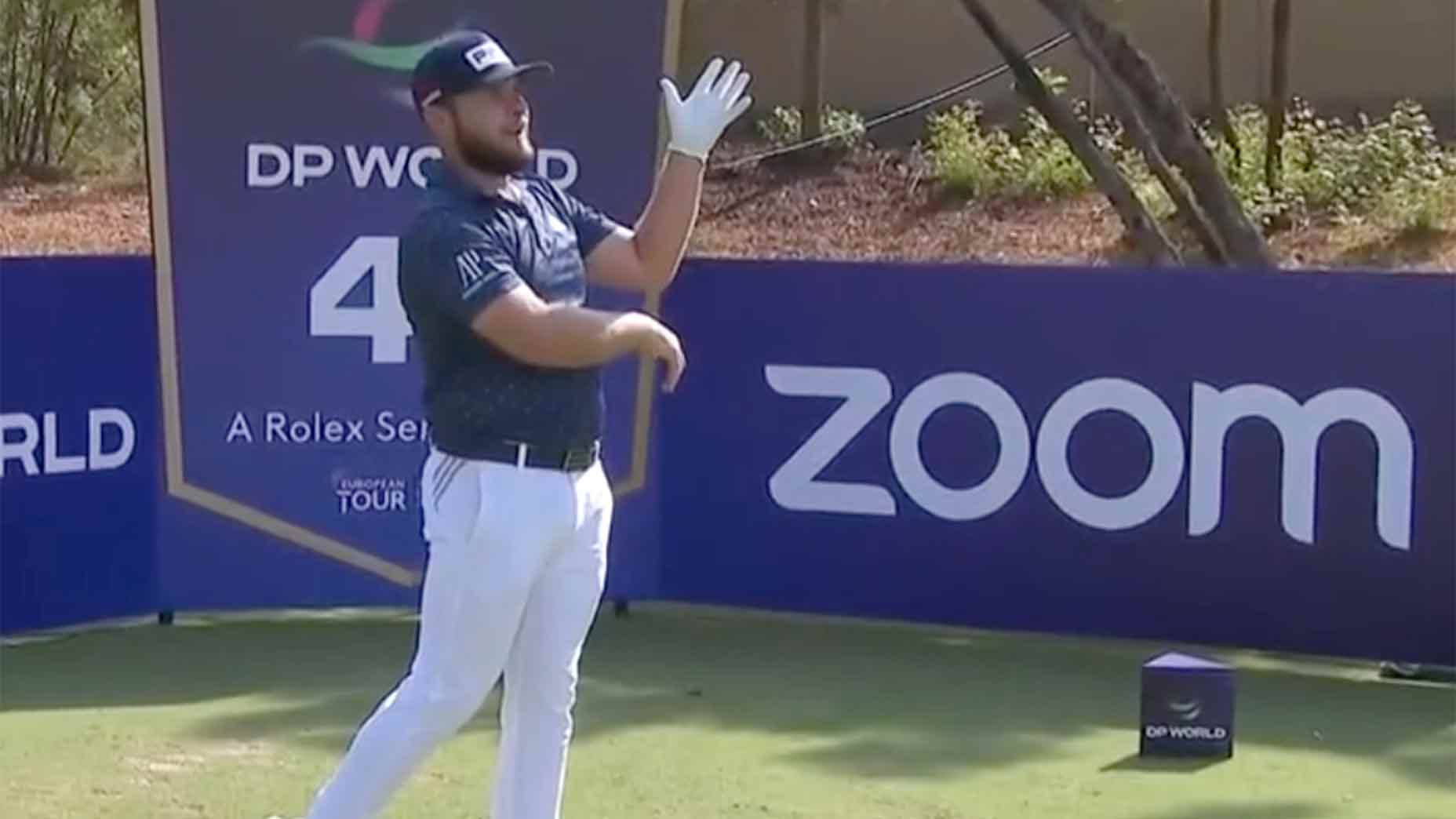 Tyrrell Hatton watches a tee shot.