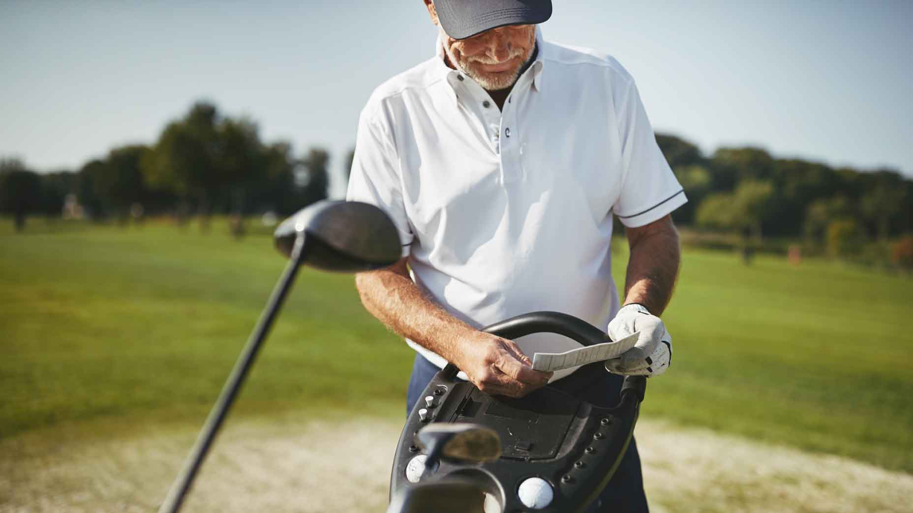 Golfer reading scorecard