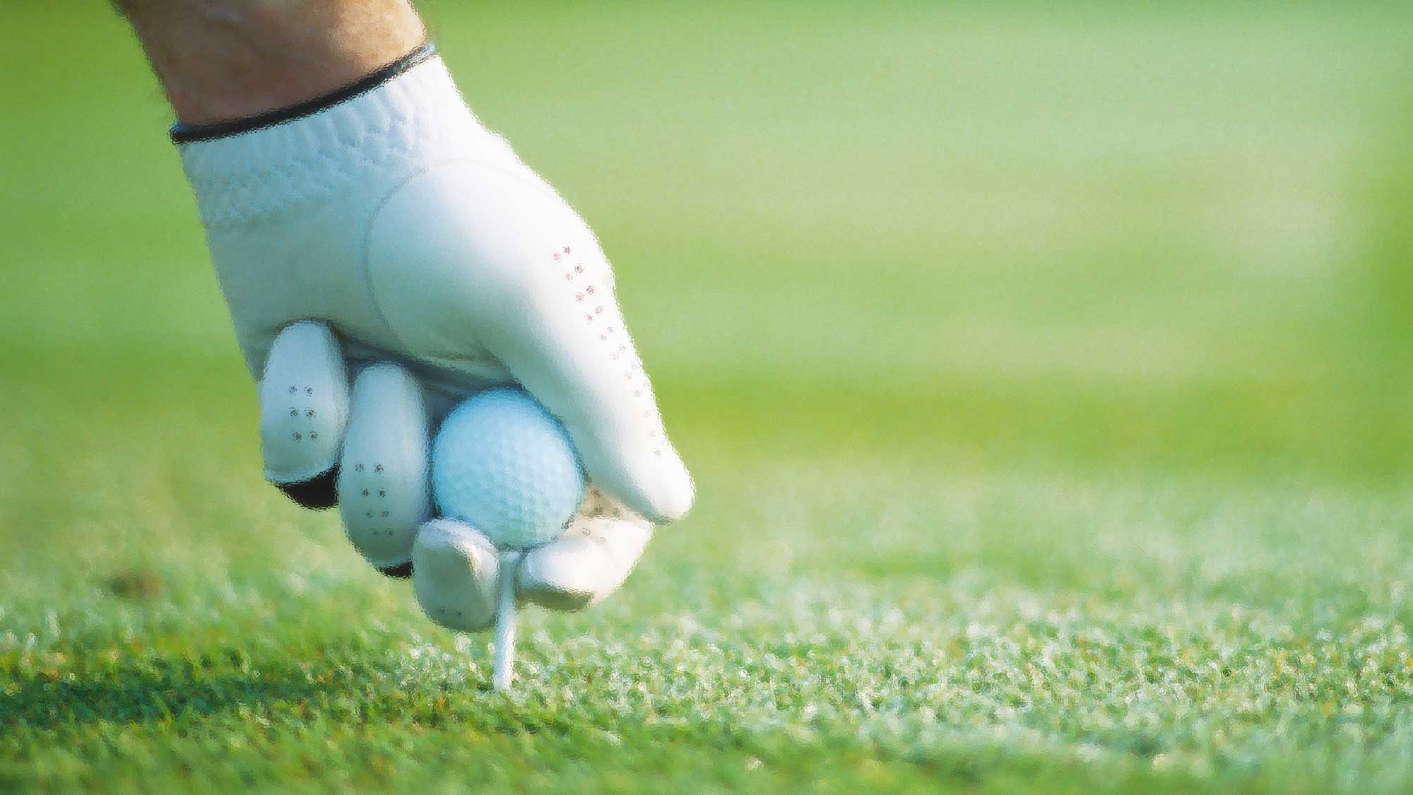 golfer teeing up ball