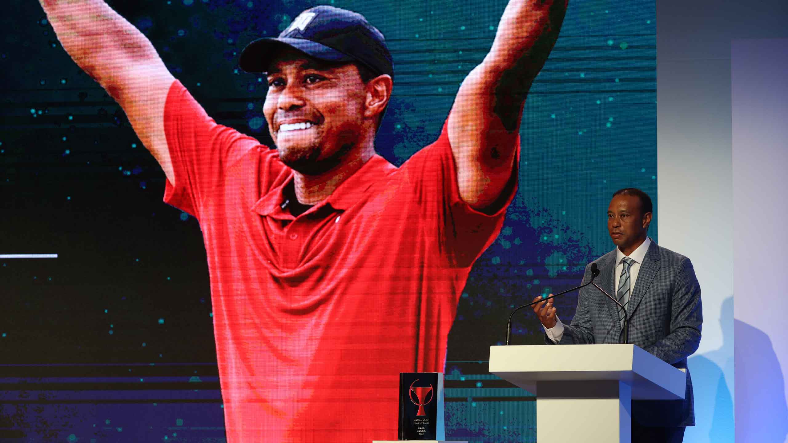 tiger woods stands at lectern