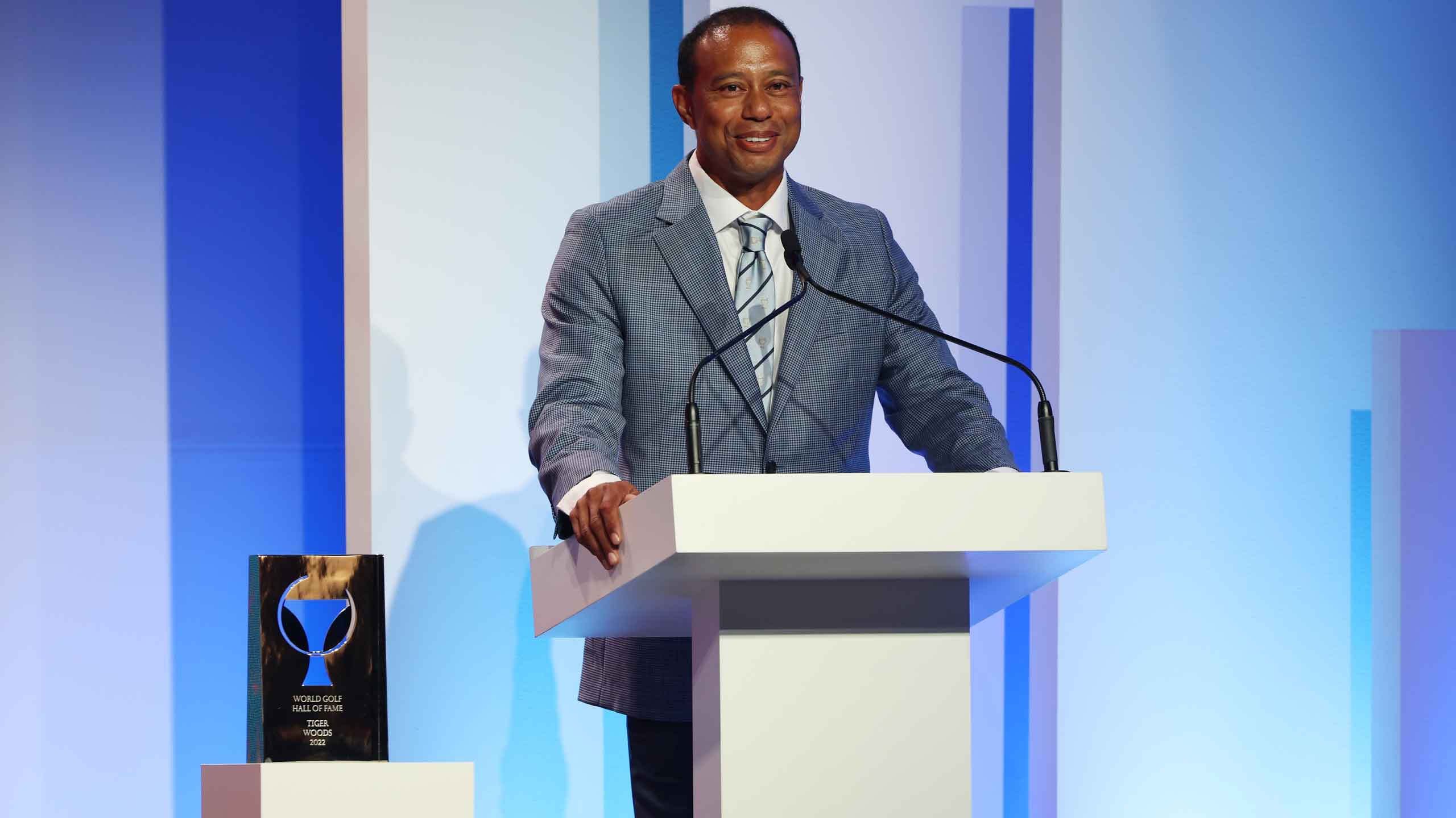 tiger woods stands at lectern