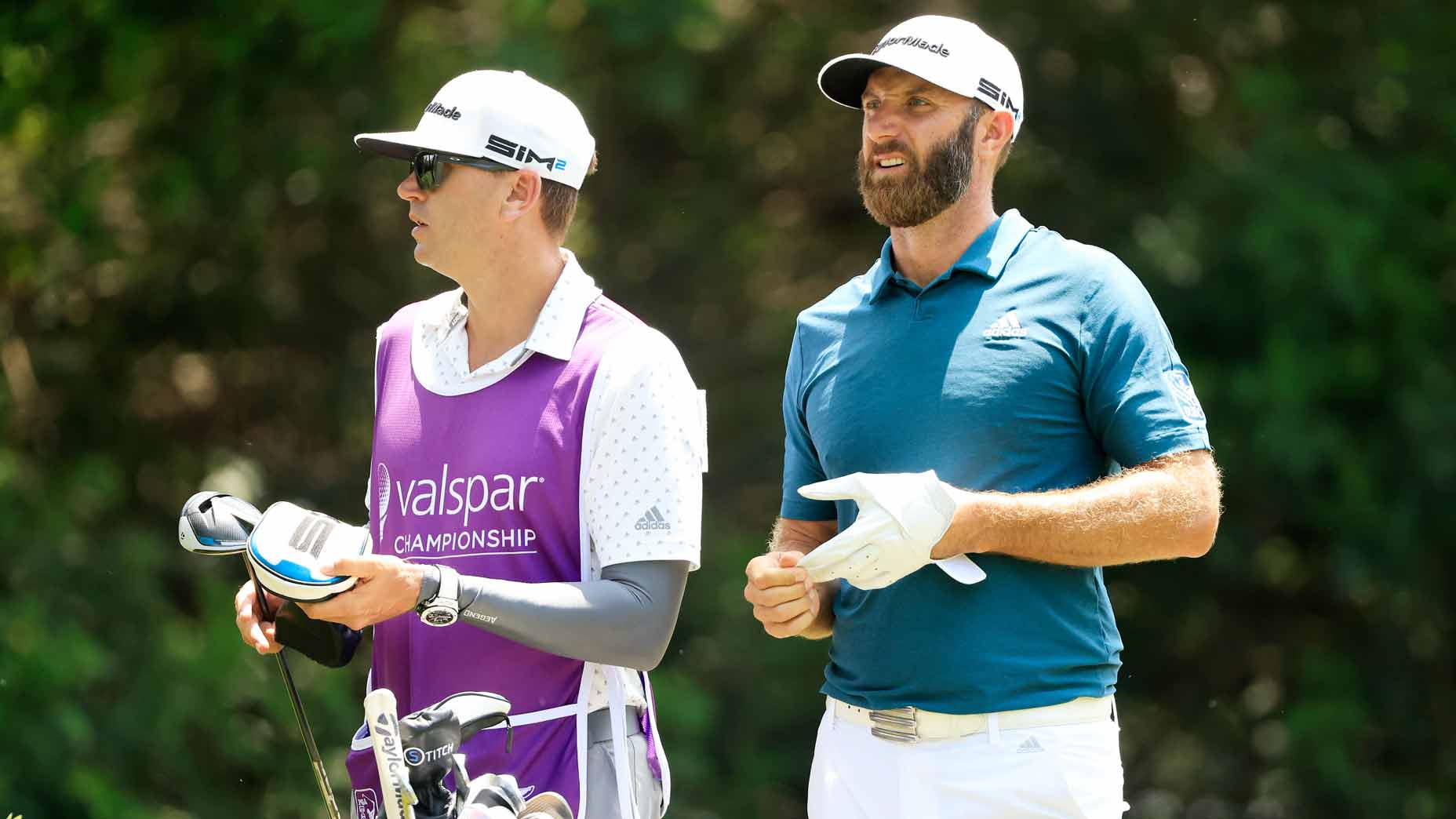 Dustin Johnson and caddie discuss shot during 2021 Valspar Championship