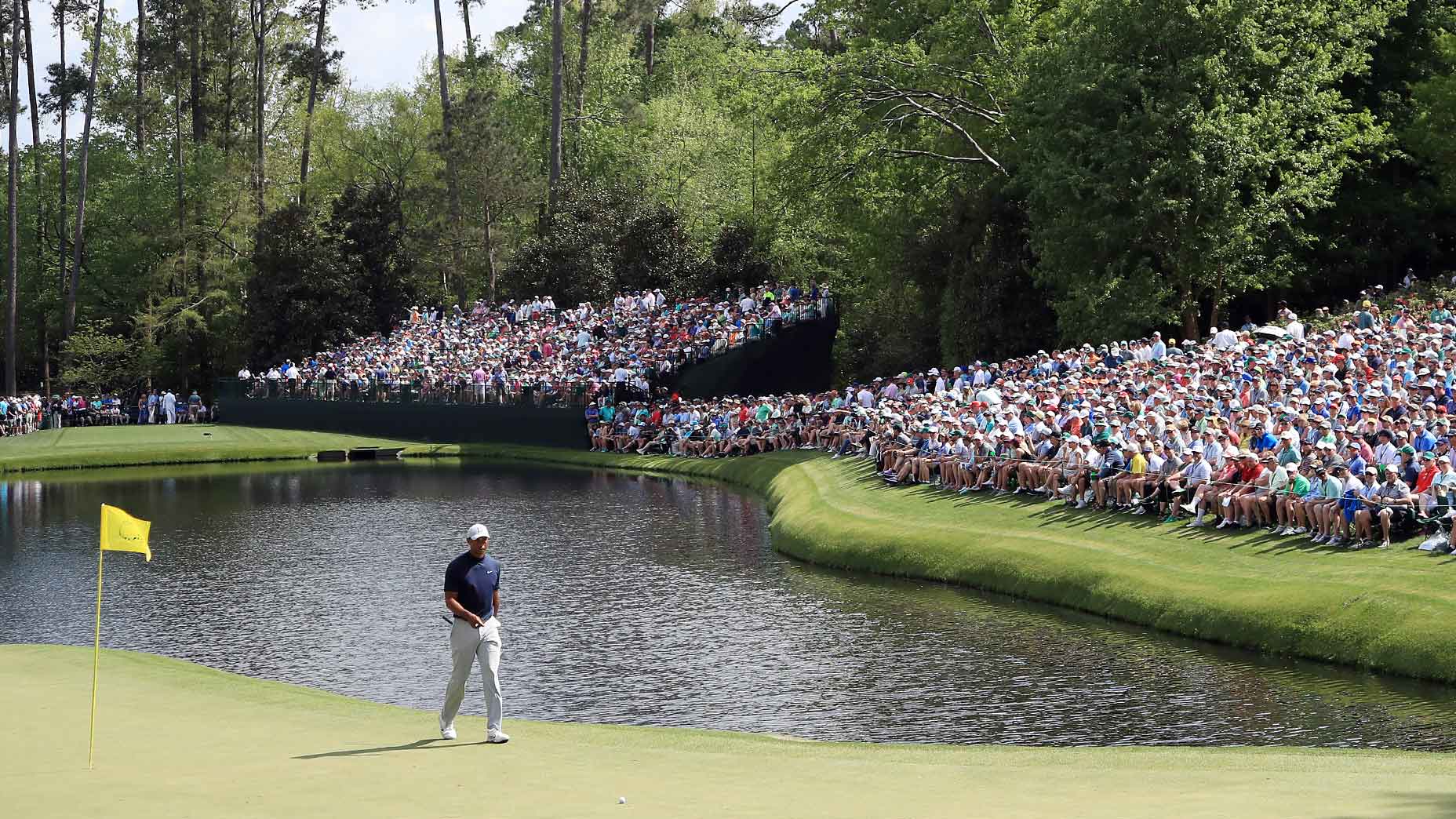 tiger woods walks in front of masters
