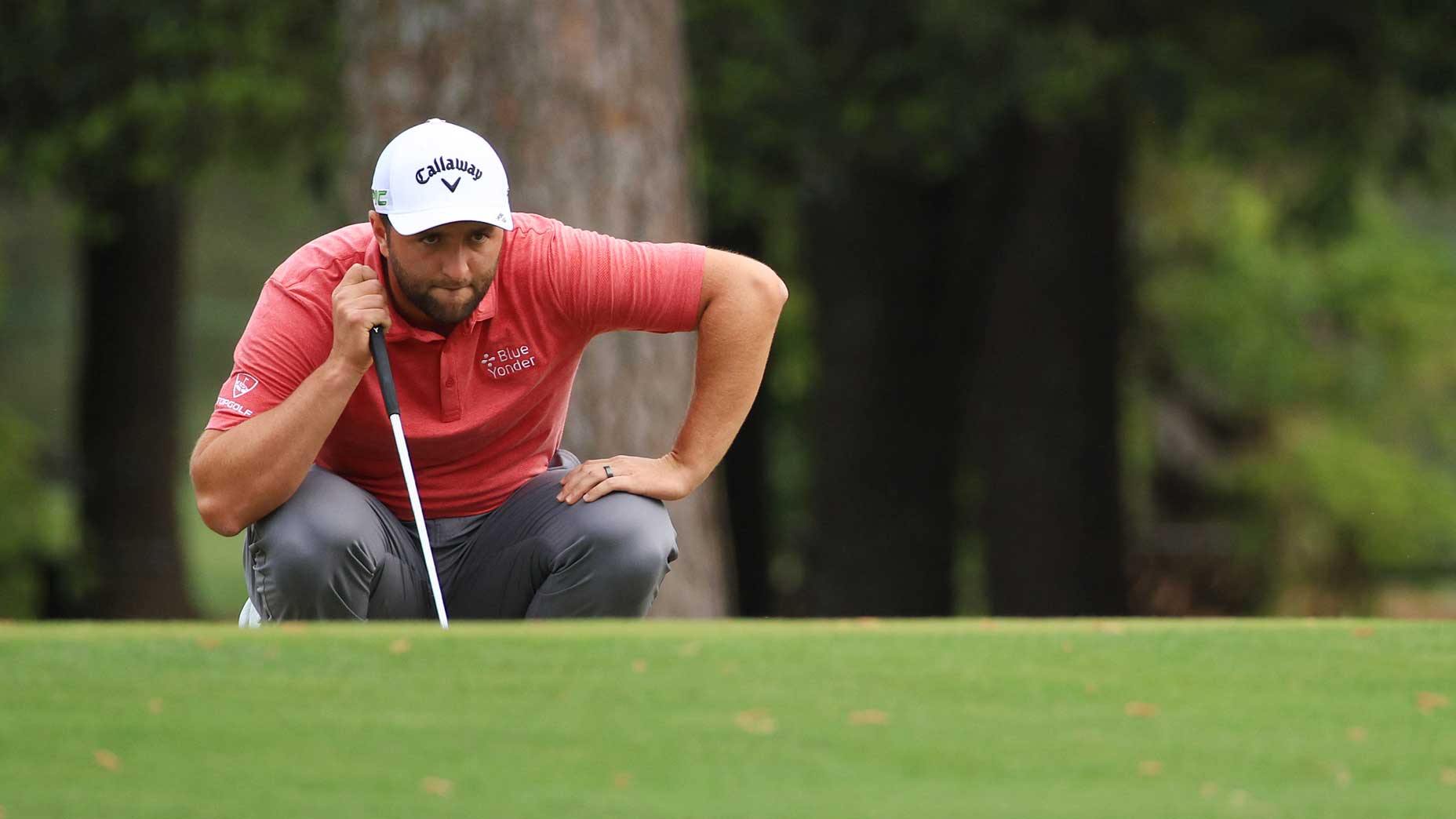 Jon Rahm reads putt at Augusta National