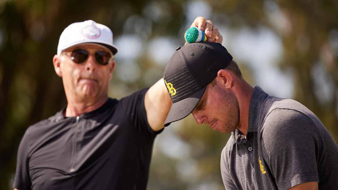 man puts hacky sack on head