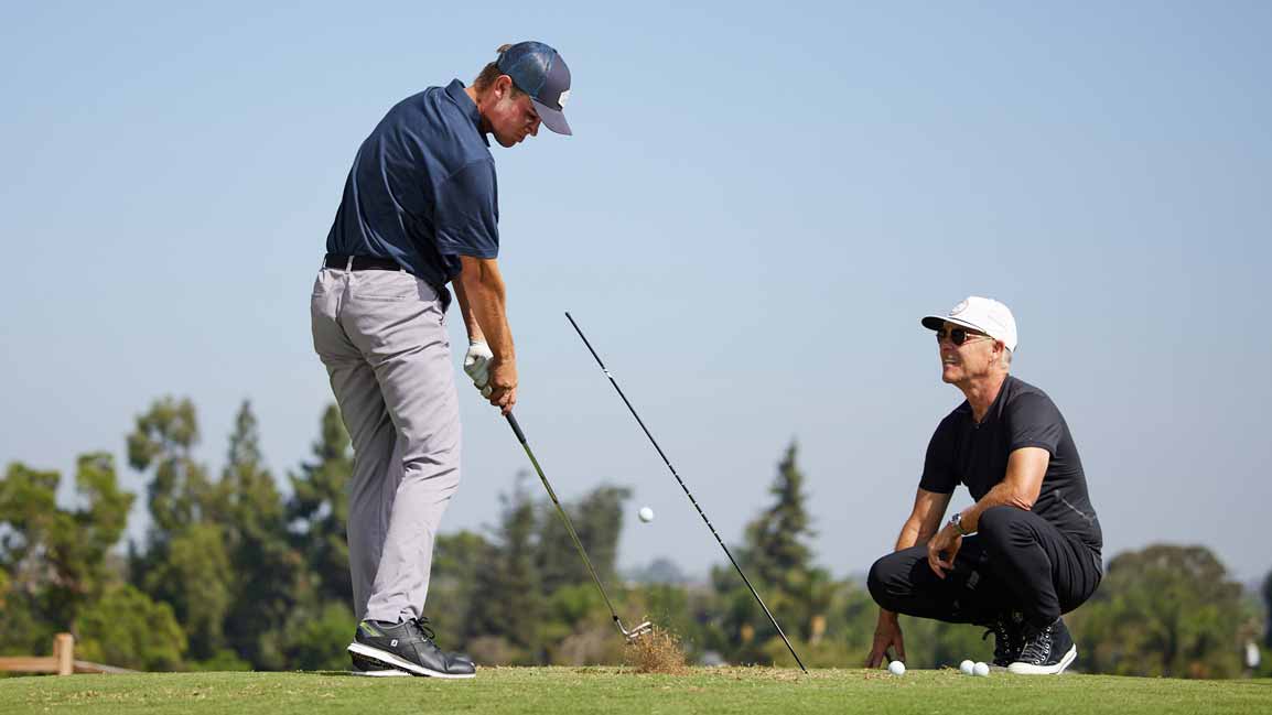 man teaches golfer