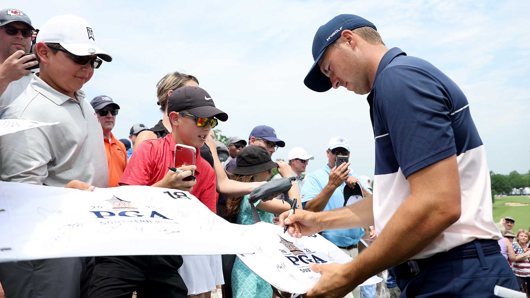 Jordan Spieth signs autographs for fans on Tuesday at the PGA Championship.