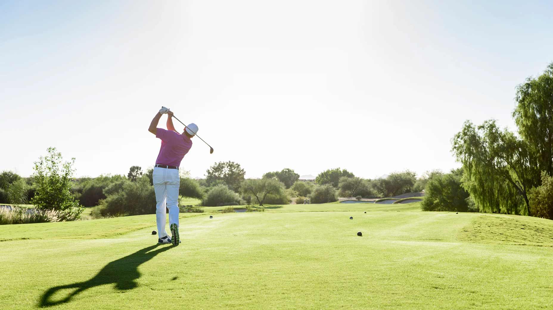 Golfer teeing off on golf course