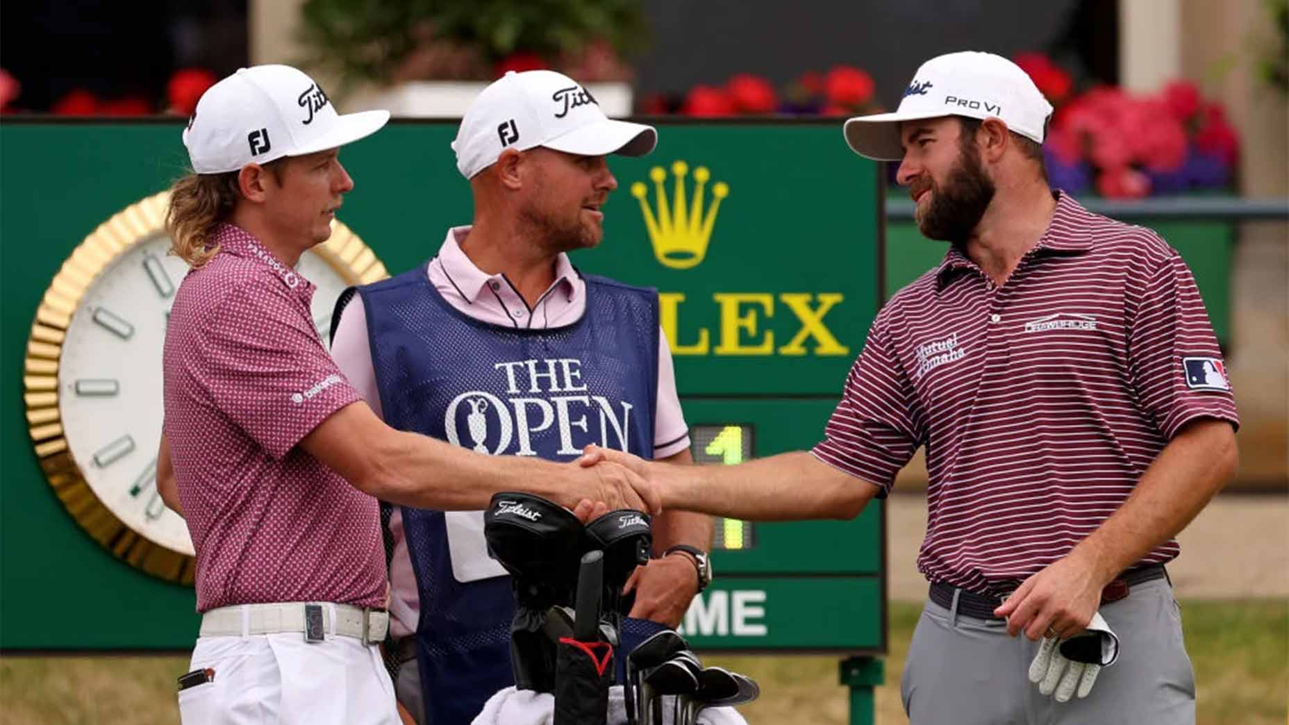 Cameron young shakes cameron smith's hand.