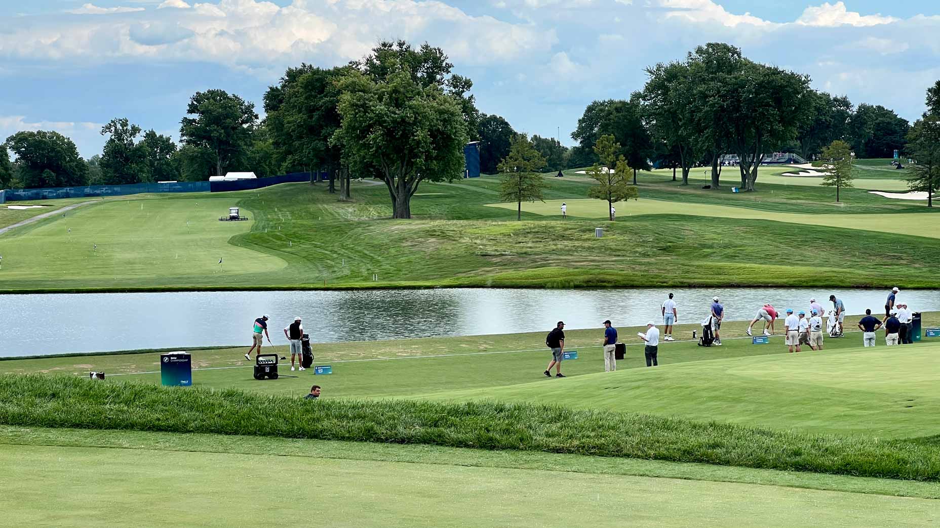 Pros hit balls at the driving range at Wilmington Country Club