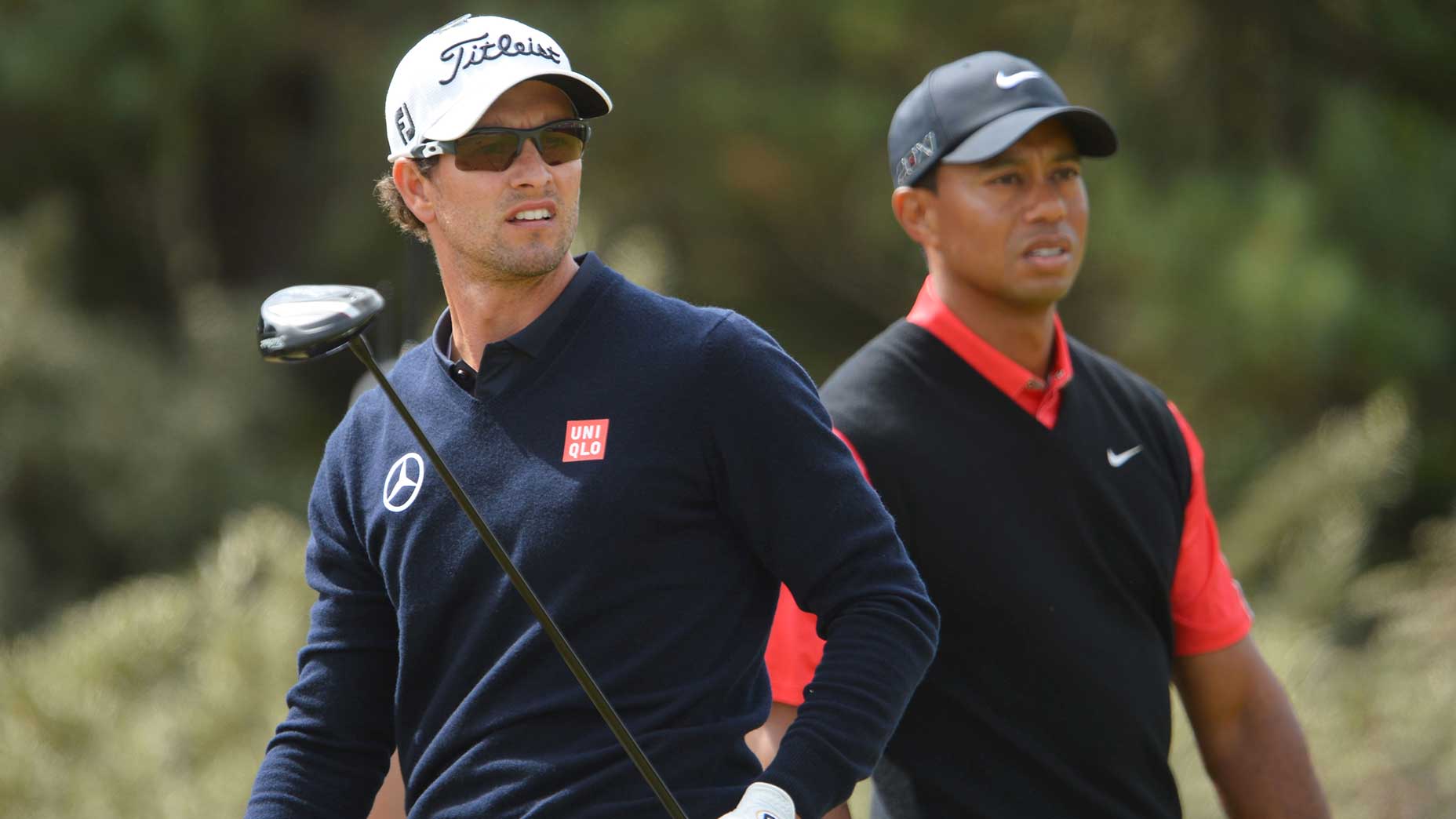 Adam Scott and Tiger Woods watch a shot.
