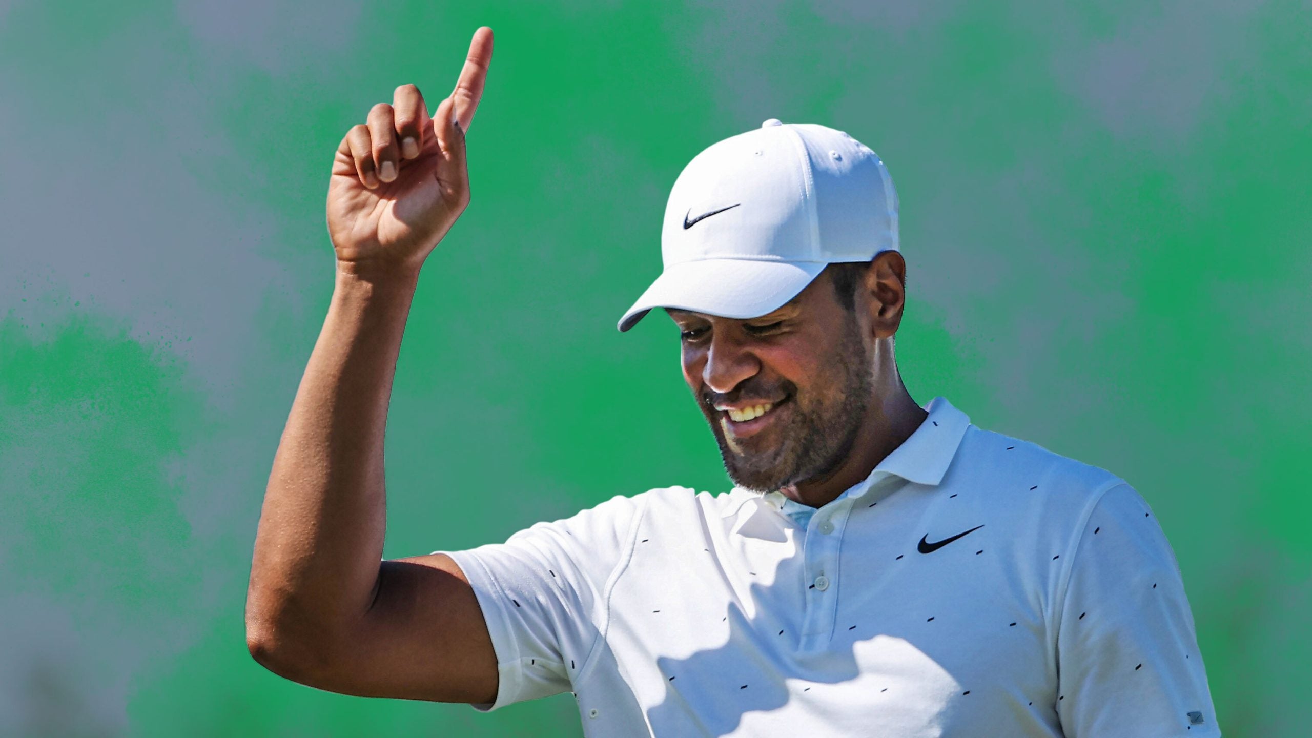 Tony Finau pointing into the air with green gas from a fart around him.