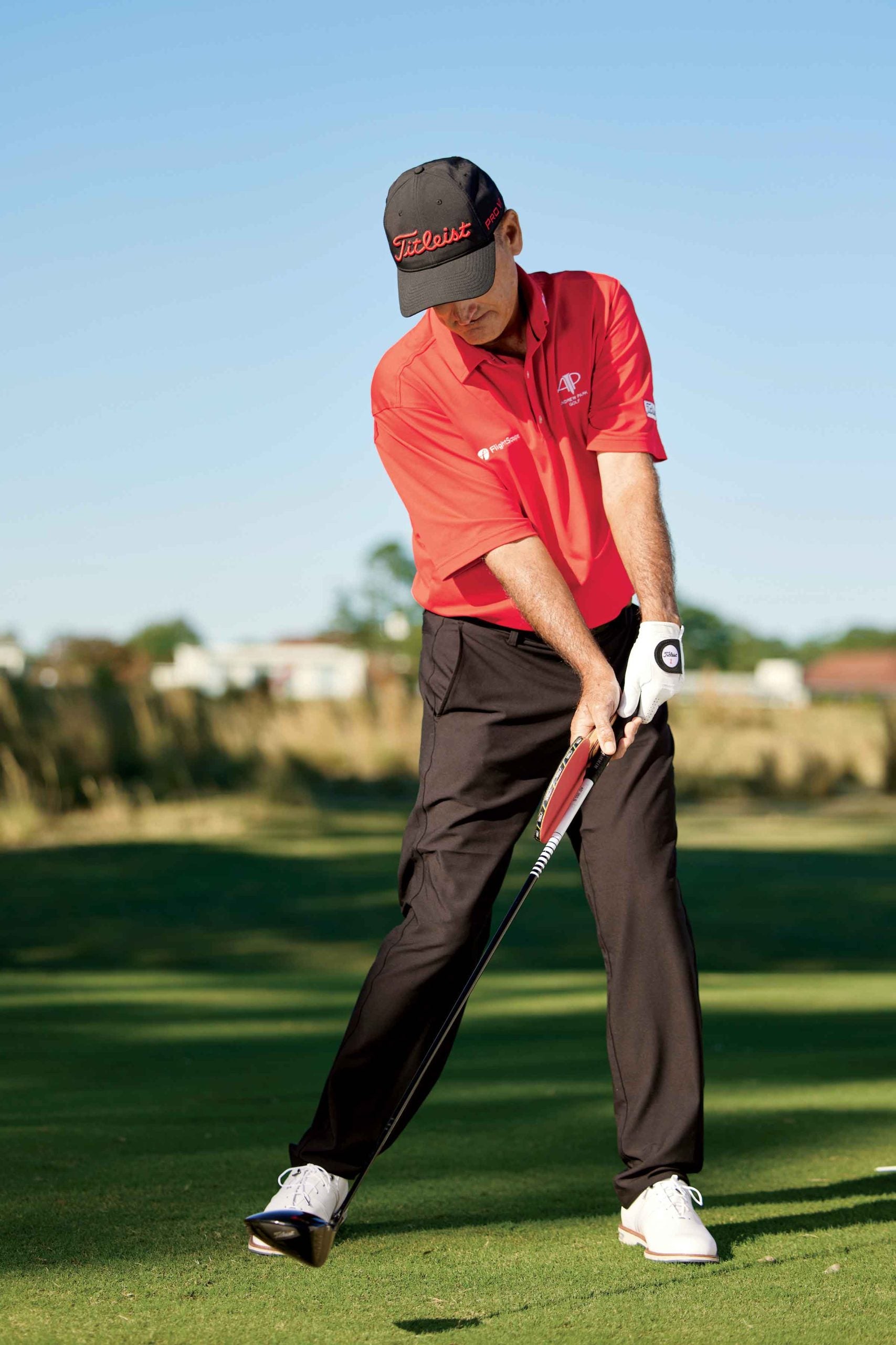 man swings golf club with ping pong paddle