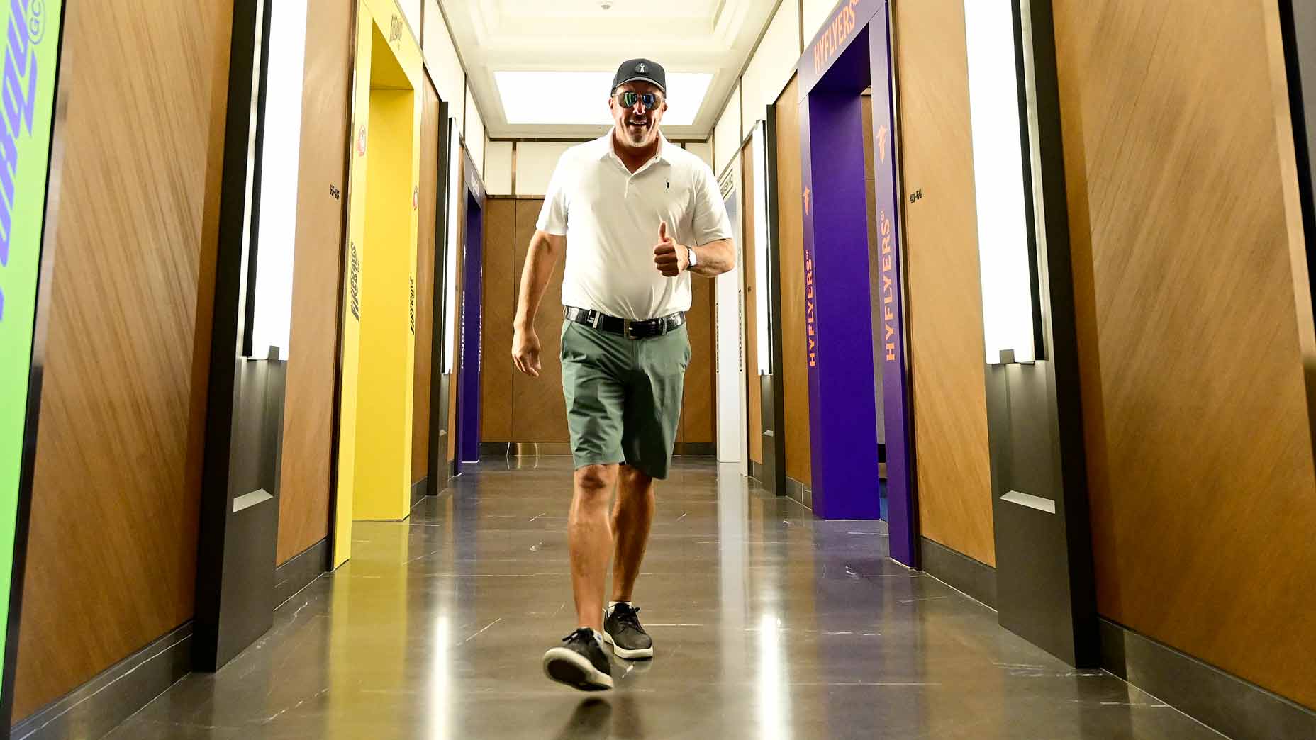 Phil Mickelson walks into locker room at LIV Golf event