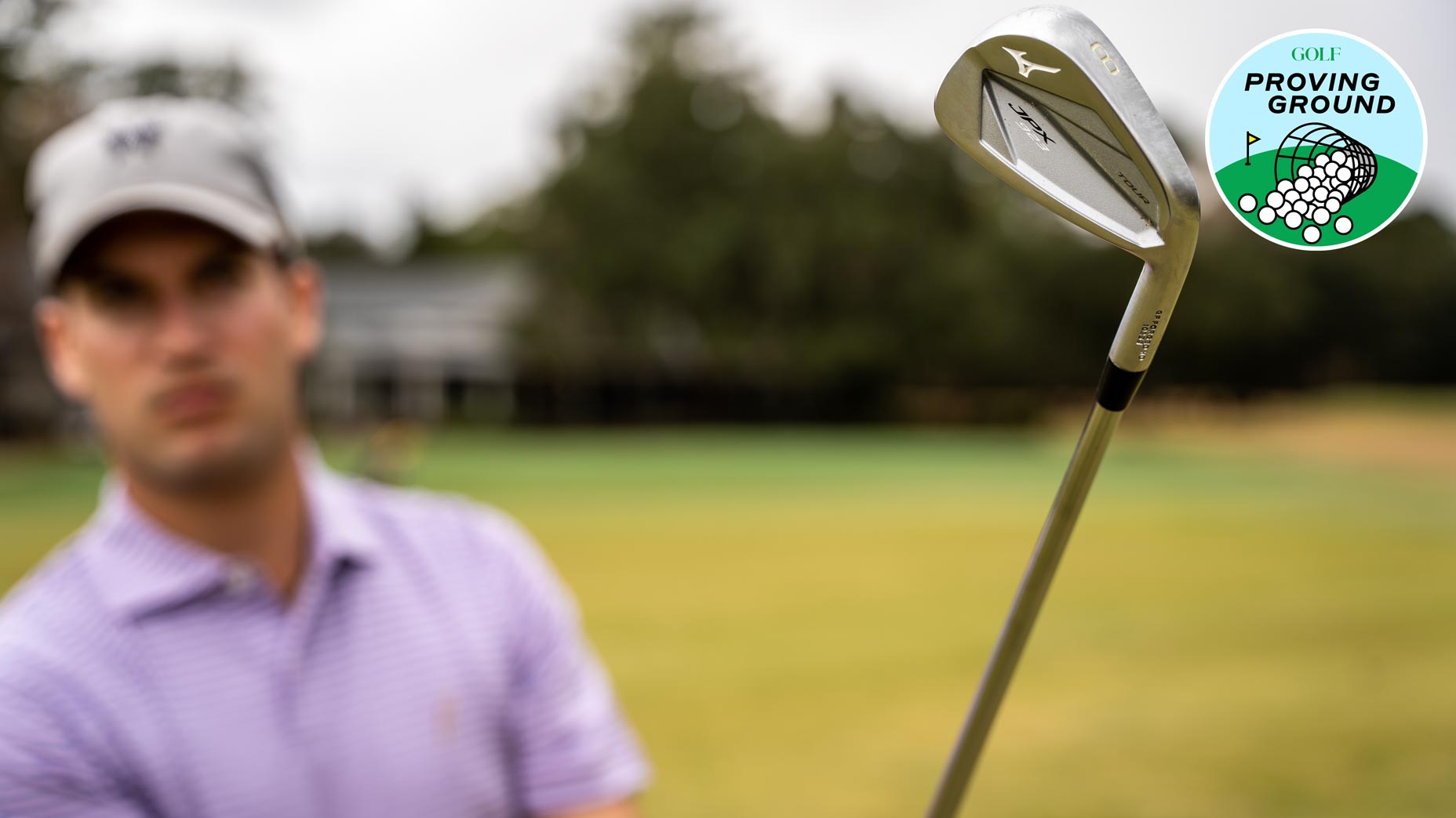 The author plays a shot with a Mizuno JPX 923 Tour 8 iron.