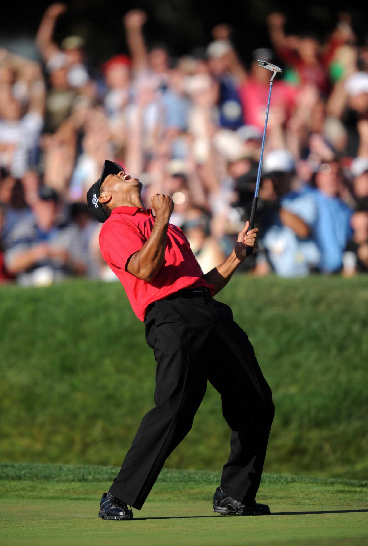 Tiger Woods of the US celebrates his birdie putt on the 18th hole in the fourth round of the 108th U.S. Open golf tournament at Torrey Pines Golf Course in San Diego, California on June 15, 2008. Woods' finished tied for the lead with compatriot Rocco Mediate, forcing a playoff to take place on June 16.