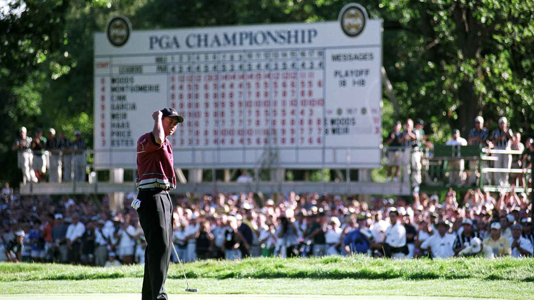 Tiger Woods celebrates as he makes the winning putt during the PGA Championships at the Medinah Country Club in Medinah, Illinois.