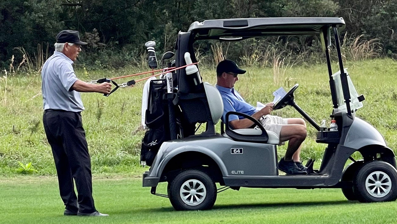 Lee Trevino stretching on the 10th tee
