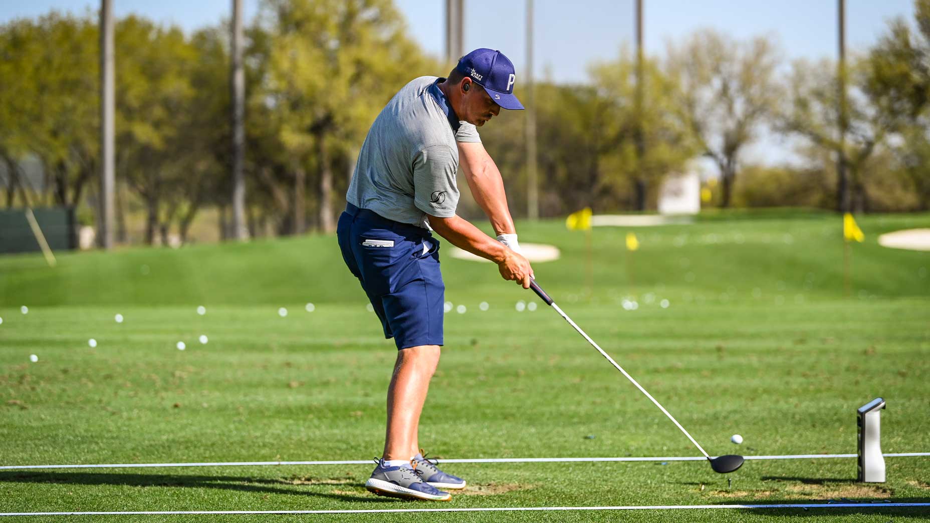 bryson dechambeau hits ball