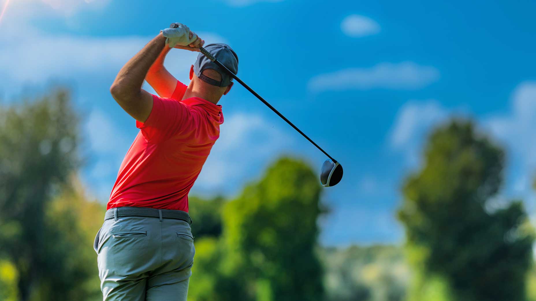 a golfer swings