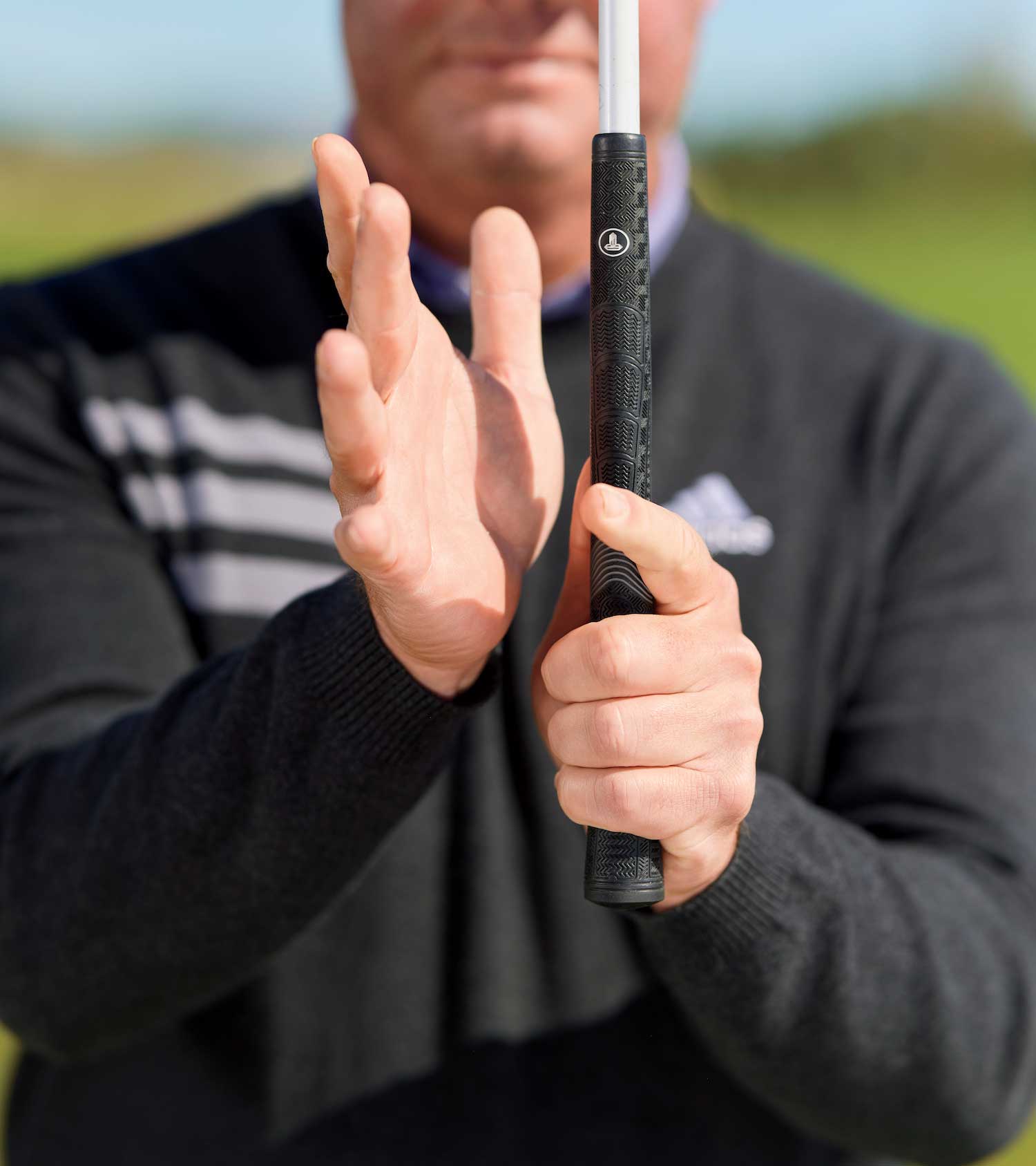 man grips club