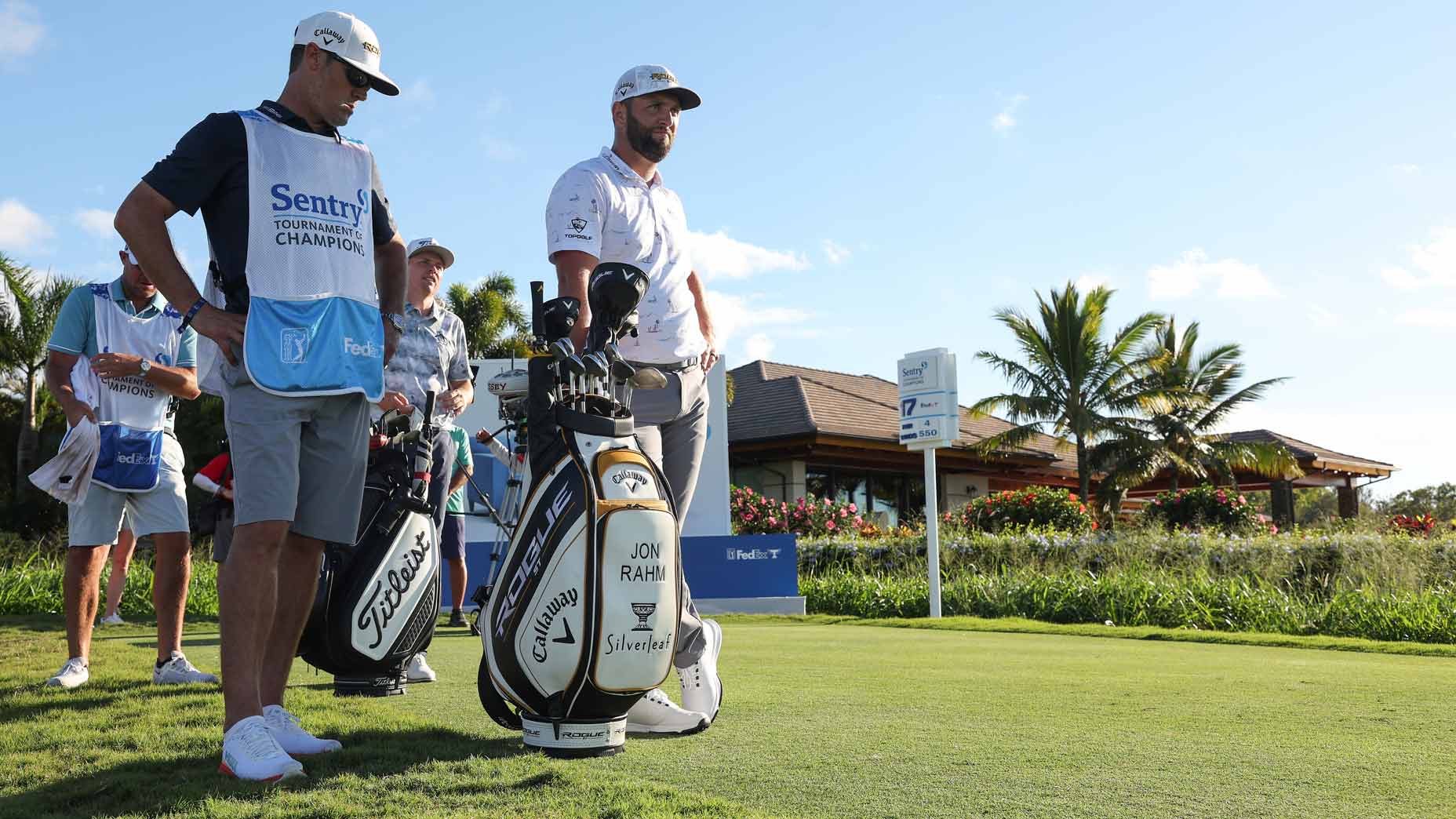 Jon Rahm and caddie wait on tee at 2022 Sentry Tournament of Champions