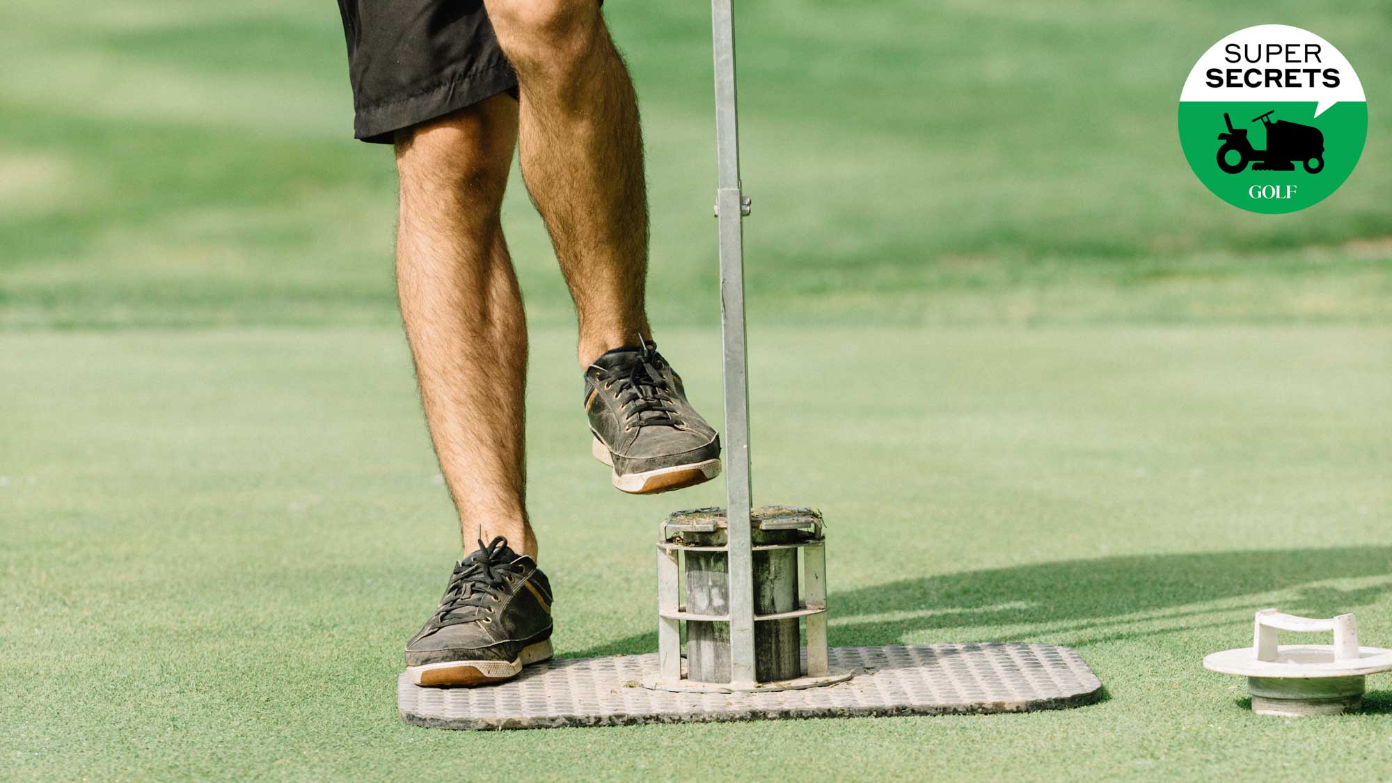 superintendent cutting a golf hole