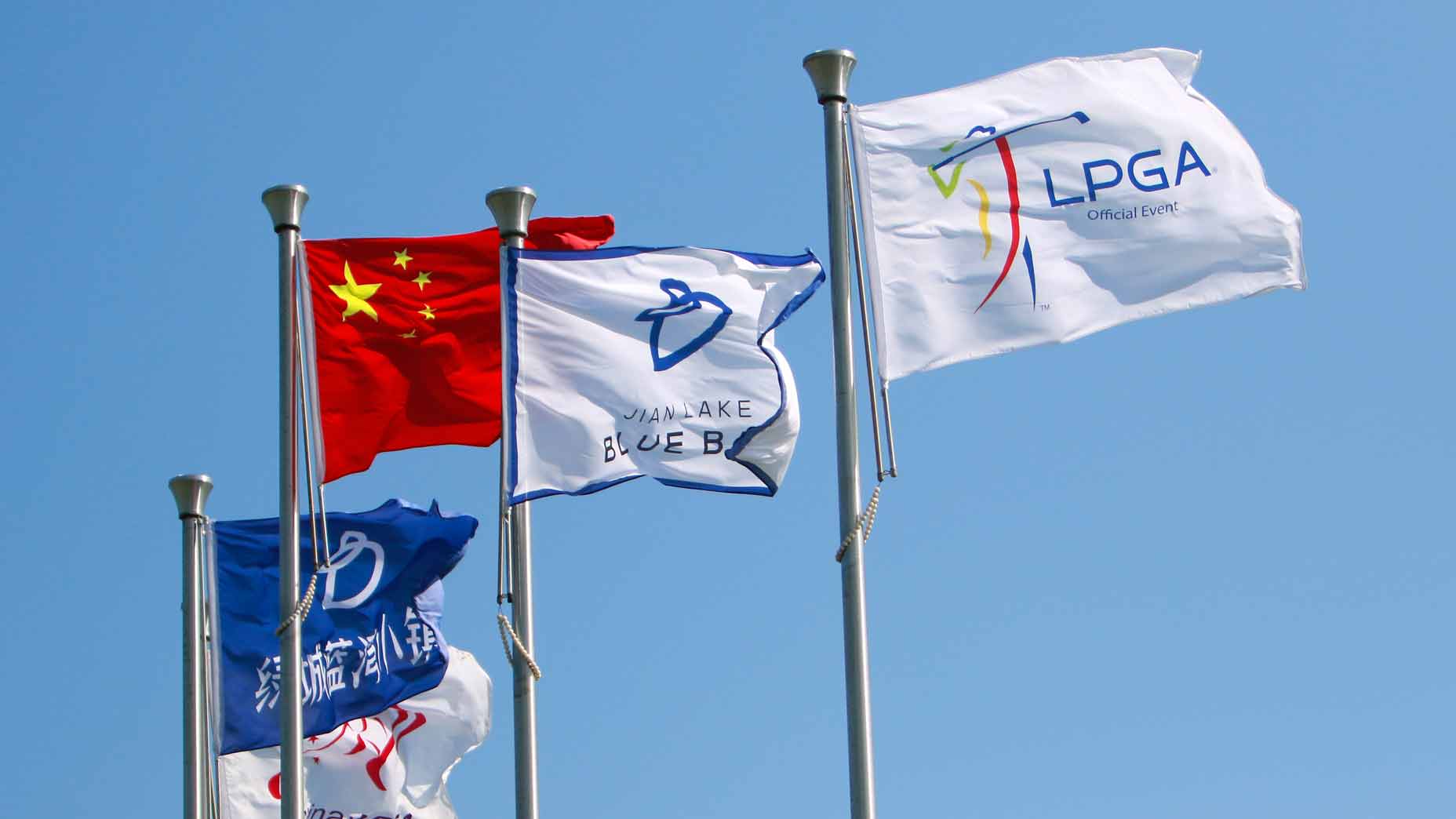four flags fly in the wind