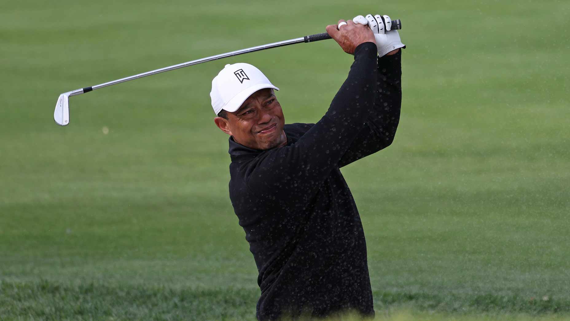 tiger woods hits a shot on friday