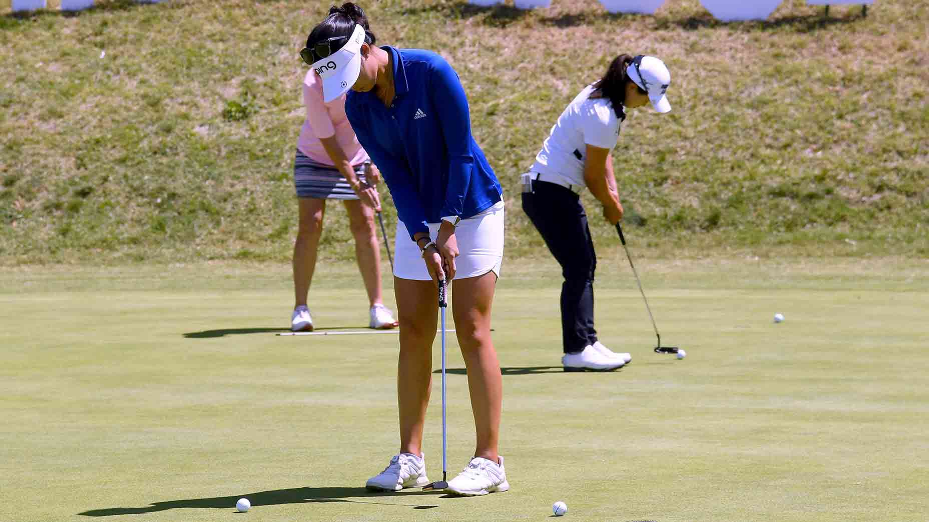 women on putting green