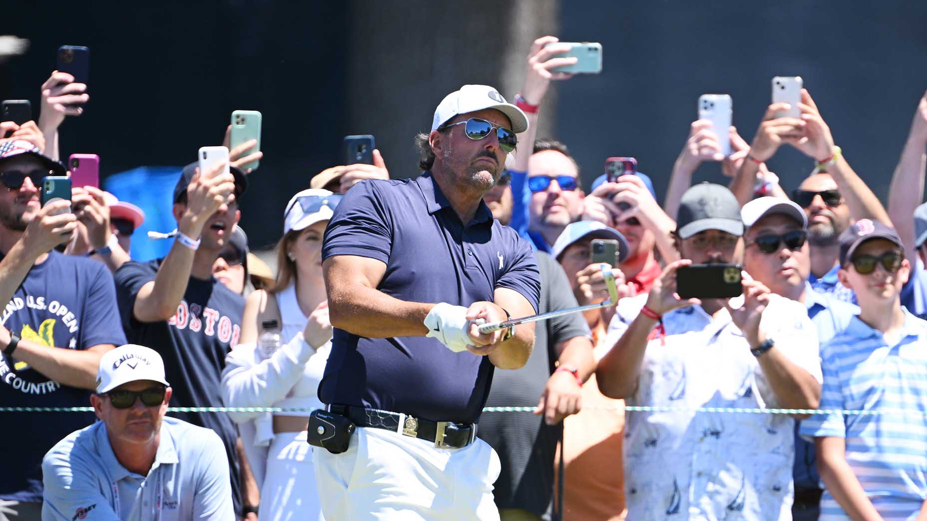 Phil Mickelson stands in front of cameras