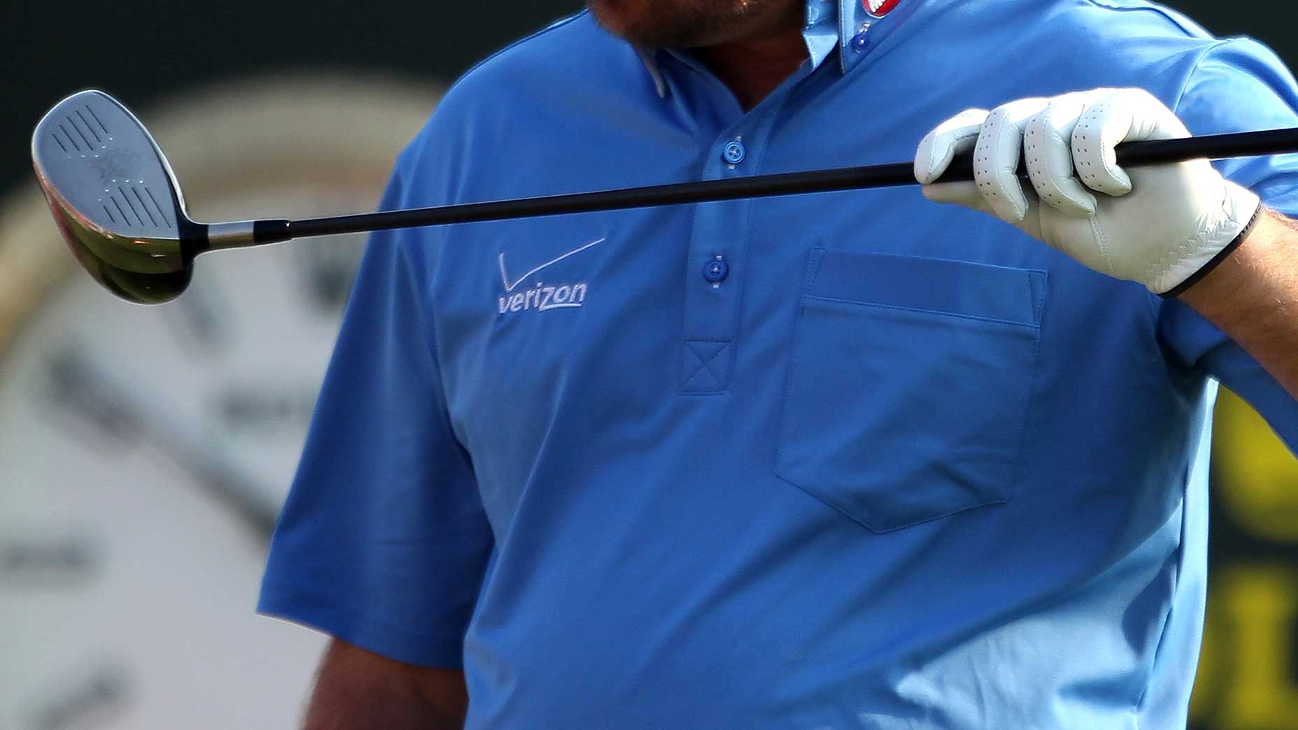 a player looks at their damaged golf club