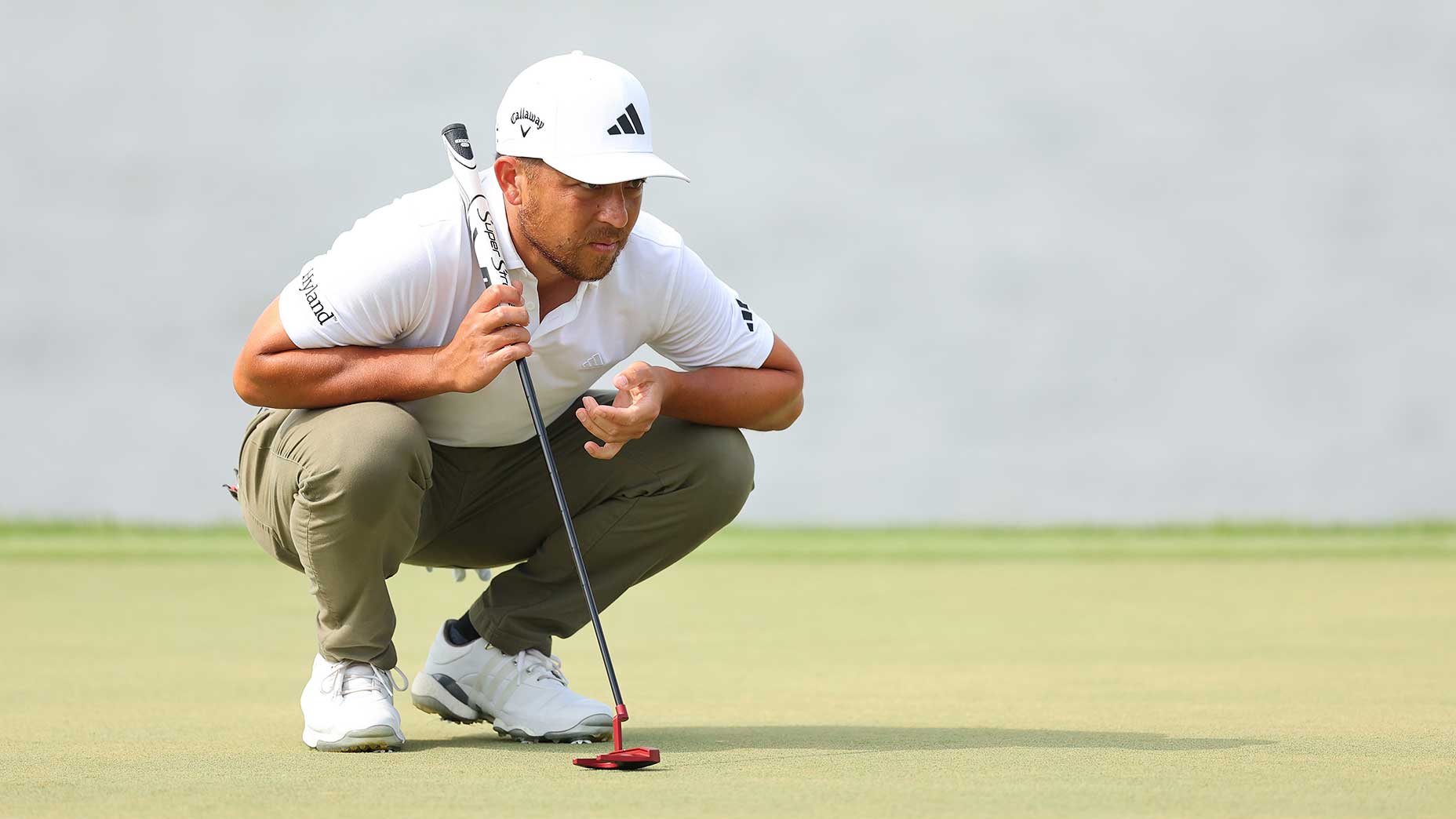 Xander Schauffele reads a putt