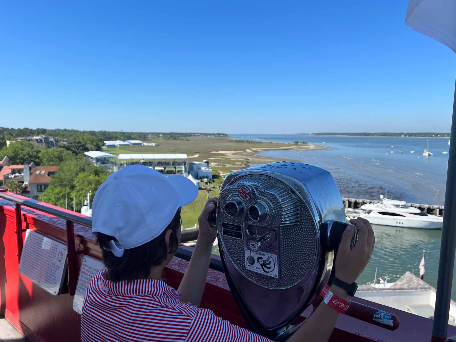 John Gorsuch looks out from a set of binoculars from the Harbour Town Lighthouse.