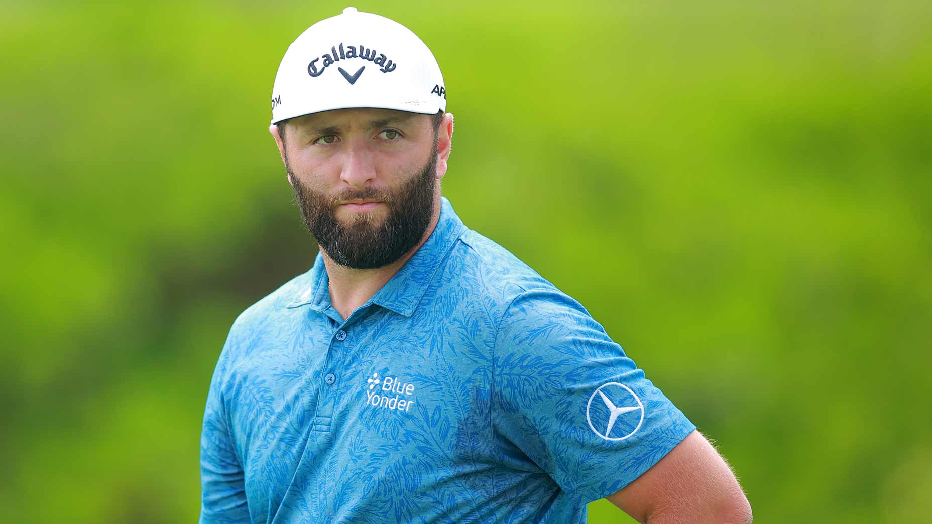 john rahm looks on at a golf tournament