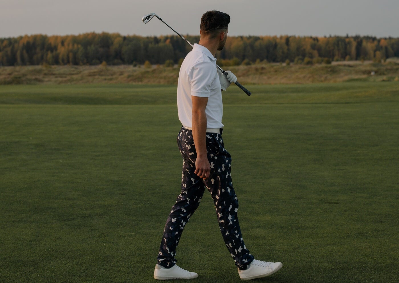 Male golfer walking on a course