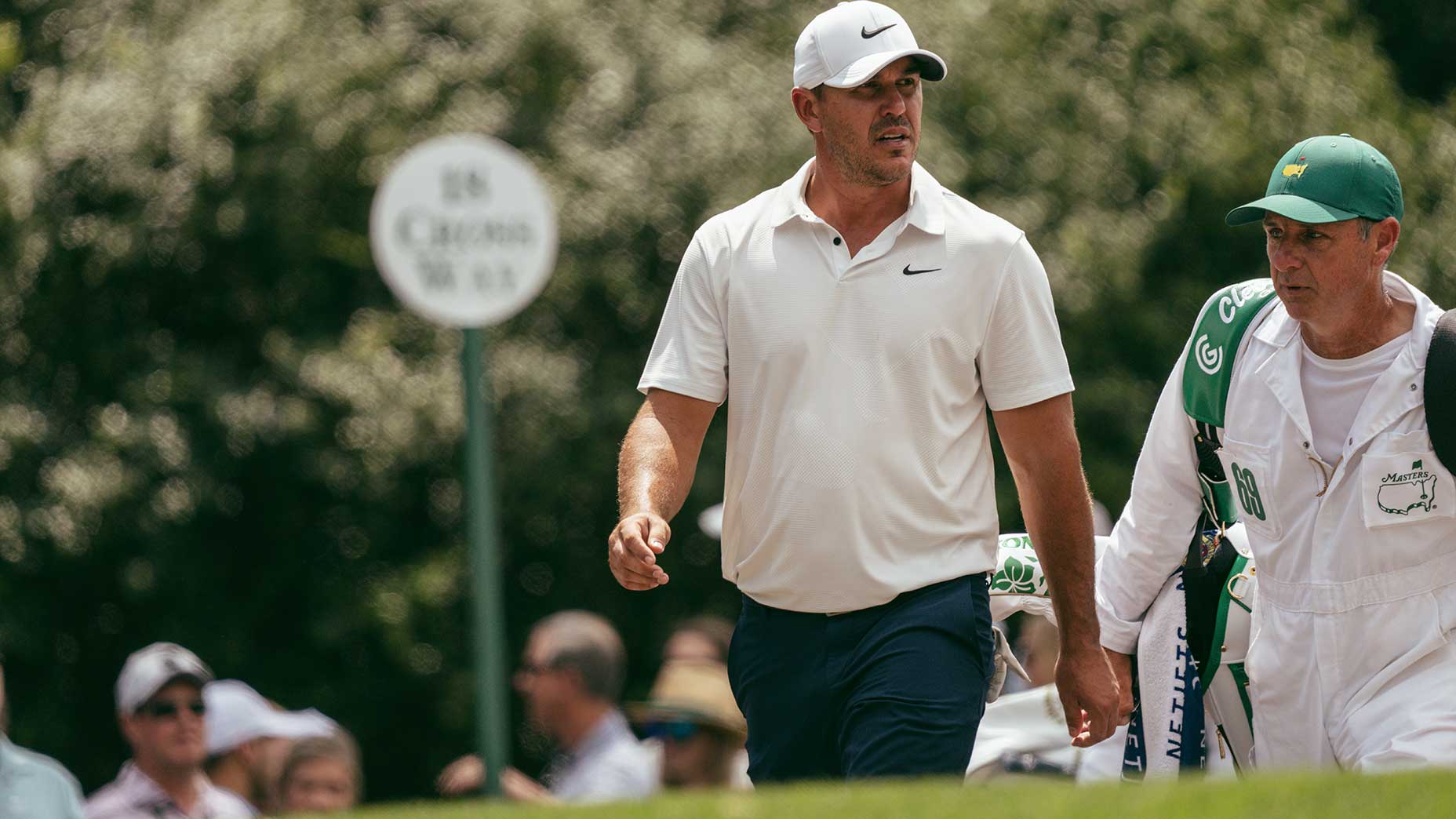 brooks koepka walks with his caddie