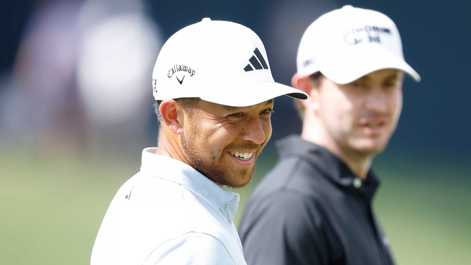 xander schauffele and patrick cantlay look on