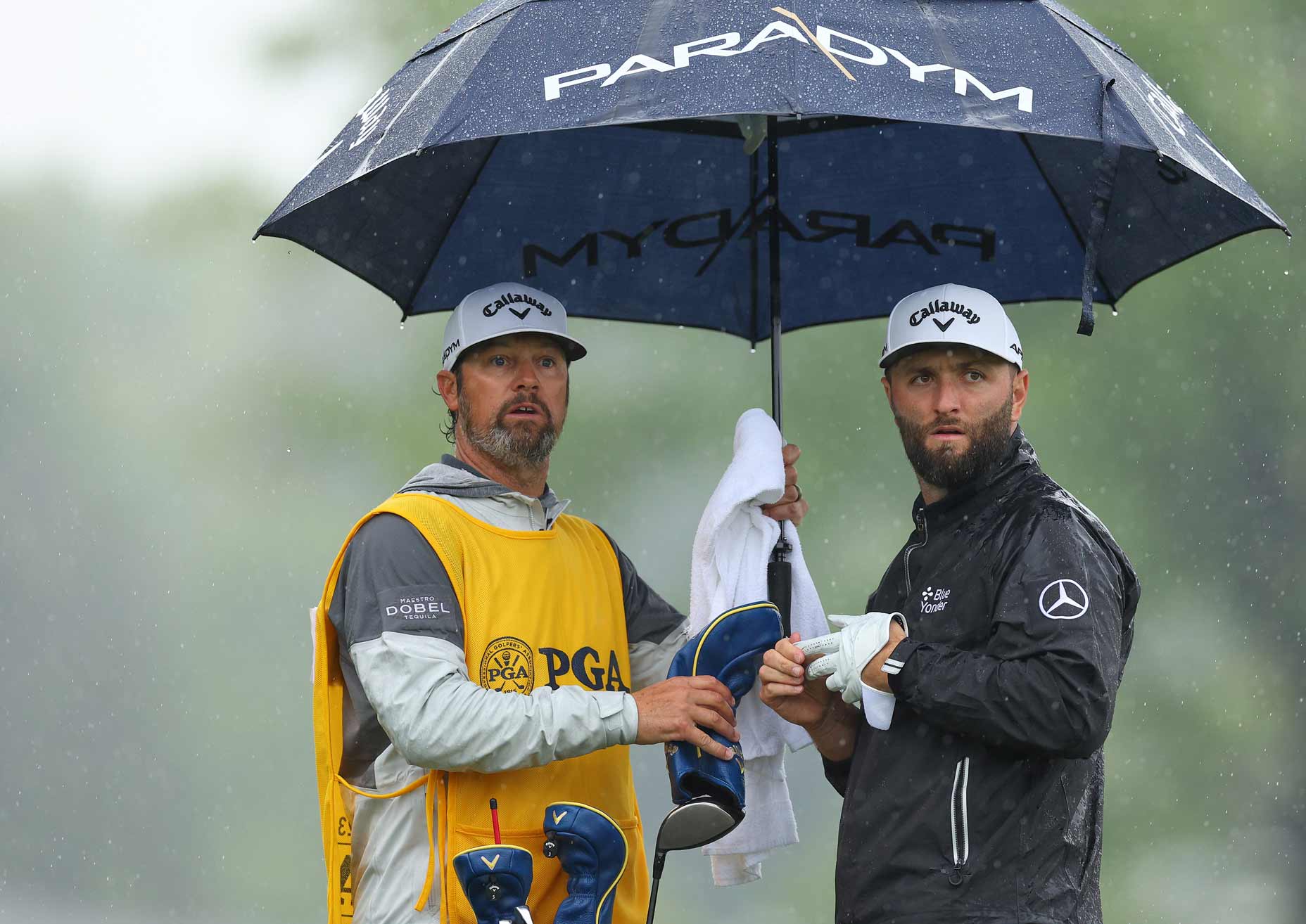 on Rahm of Spain speaks with caddie Adam Hayes on the eighth tee during the third round of the 2023 PGA Championship at Oak Hill Country Club on May 20, 2023 in Rochester, New York.