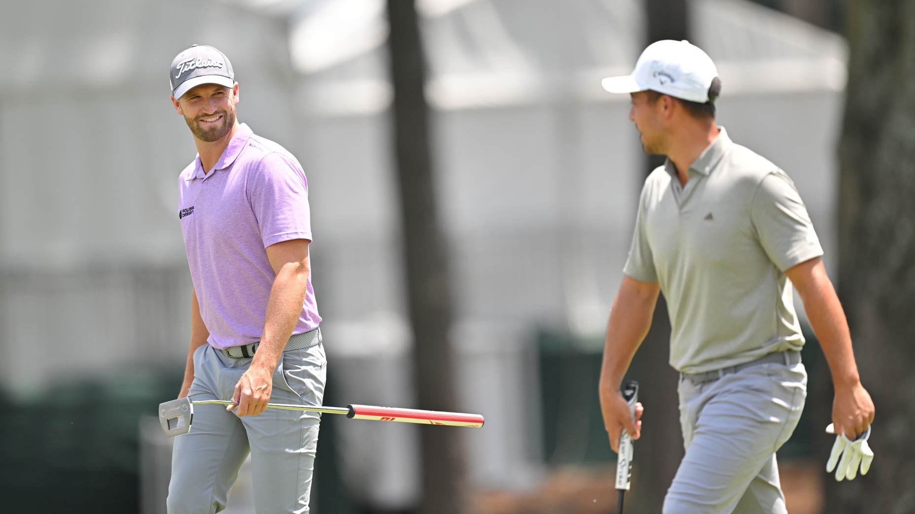 Xander Schauffele and Wyndham Clark laugh while waking along the second fairway together during the third round of the Wells Fargo Championship at Quail Hollow Club on May 6, 2023 in Charlotte, North Carolina.