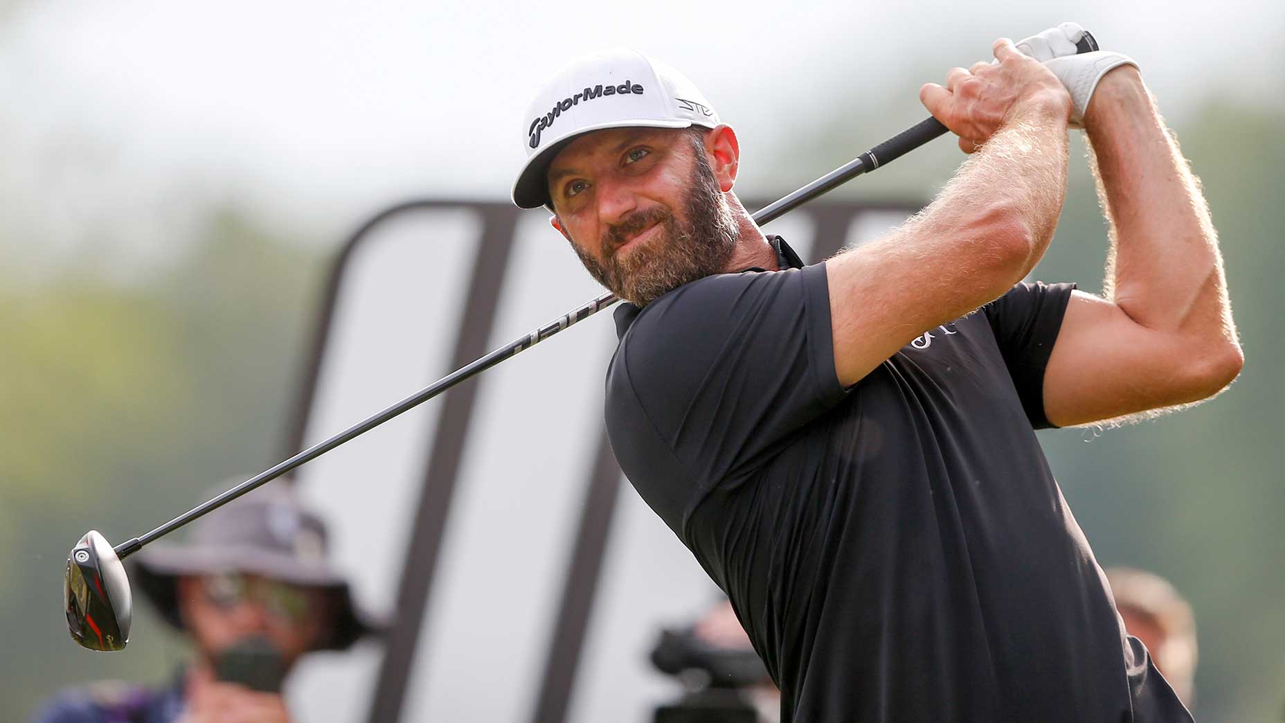 dustin johnson watches a tee shot during liv golf's event on sunday in tulsa, okla.
