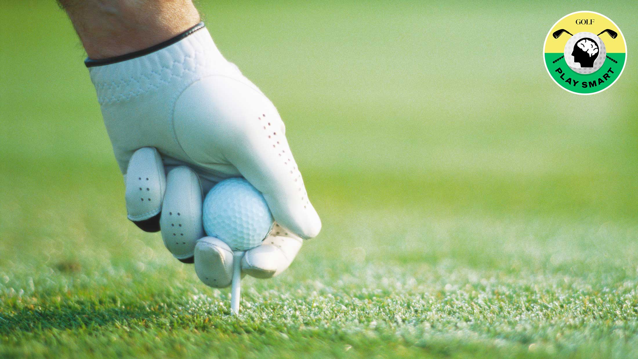 golfer placing tee in the ground