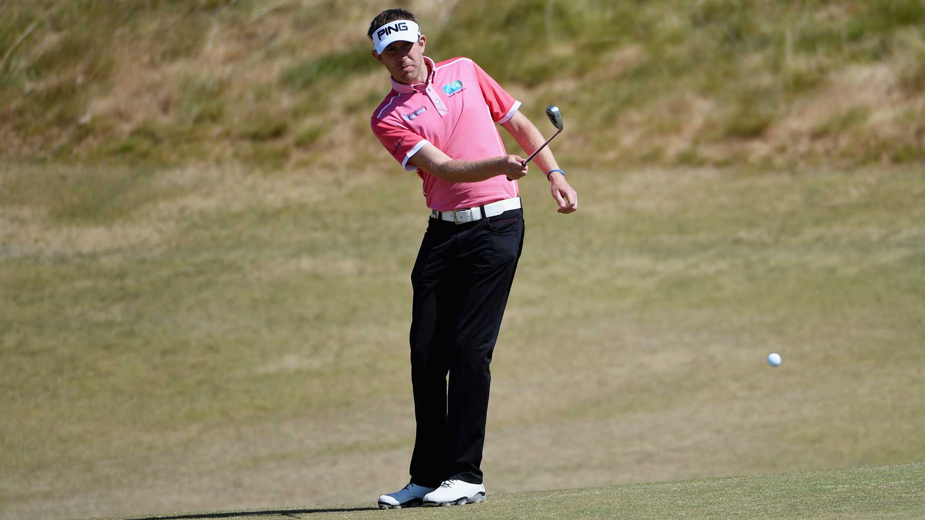 man hits one-handed chip shot