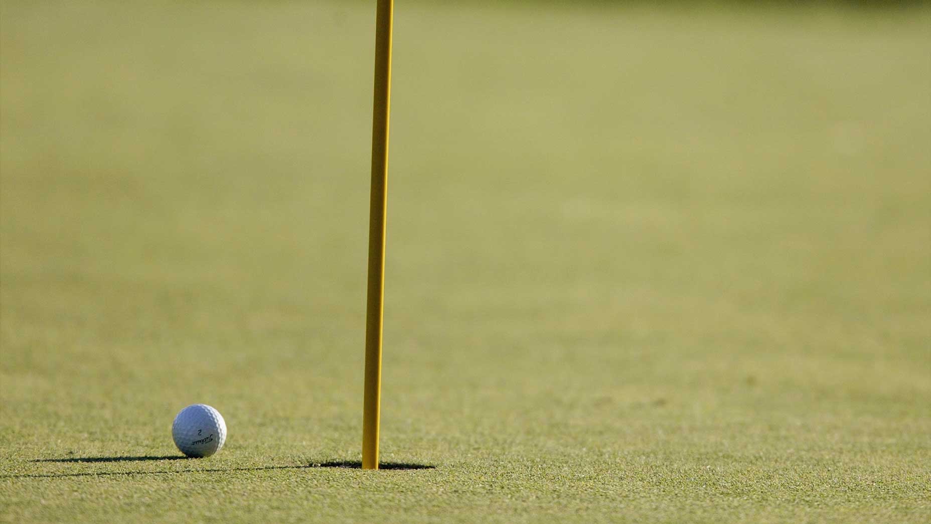 ball next to a hole and flagstick