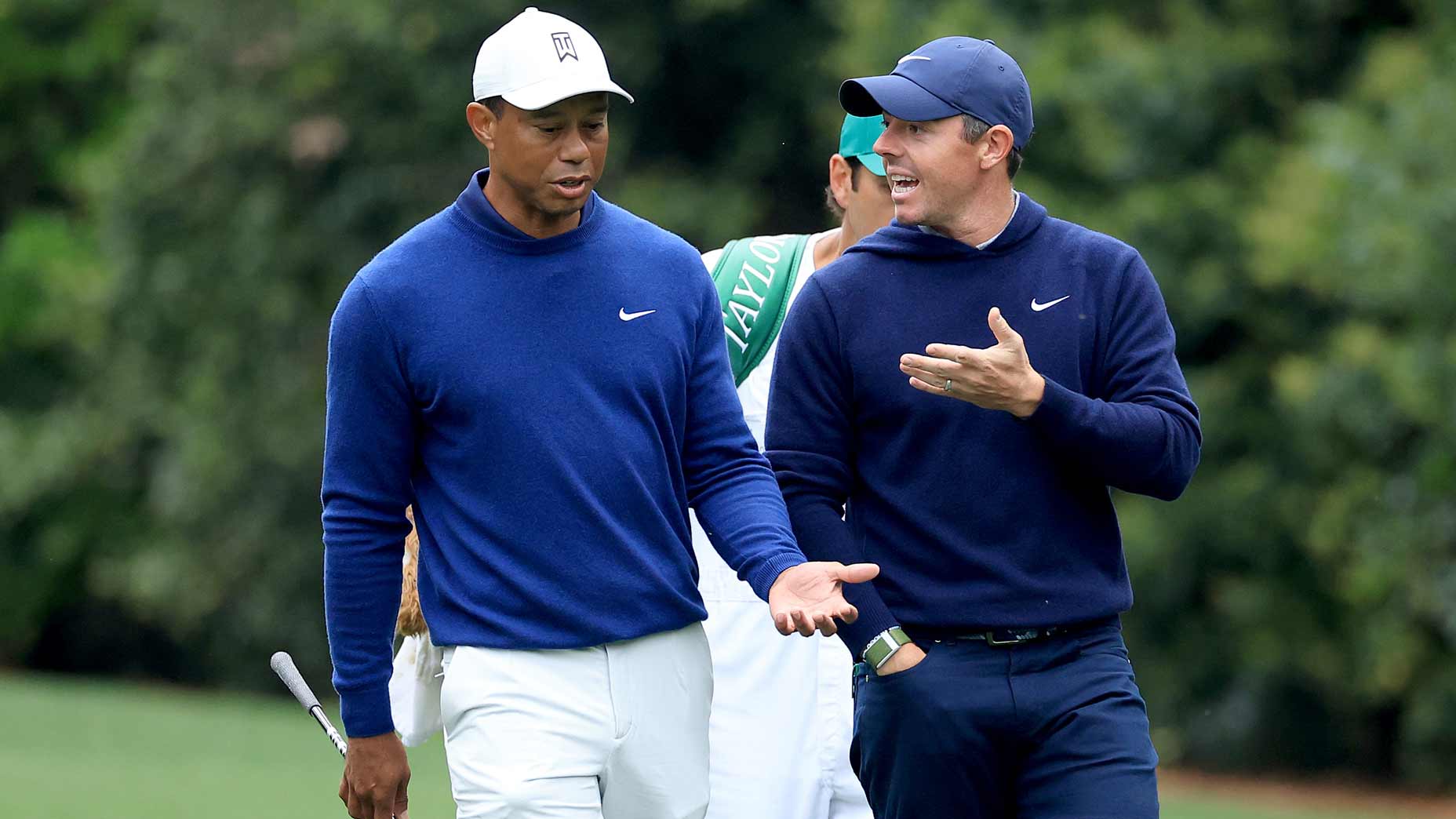 Rory McIlroy of Northern Ireland and Tiger Woods of The United States walk together on the 11th hole during a practice round prior to the 2023 Masters Tournament at Augusta National Golf Club on April 03, 2023 in Augusta, Georgia.