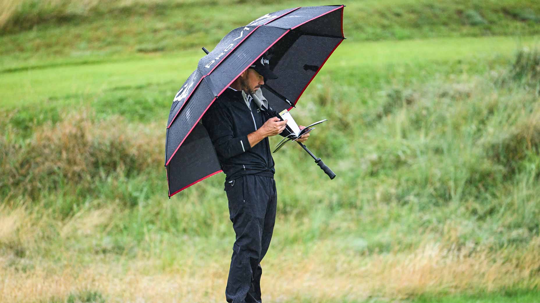 Brian Harman checks his yardage book and scorecard on the 11th hole green during the final round of The 151st Open Championship at Royal Liverpool Golf Club on July 23, 2023 in Hoylake, England.