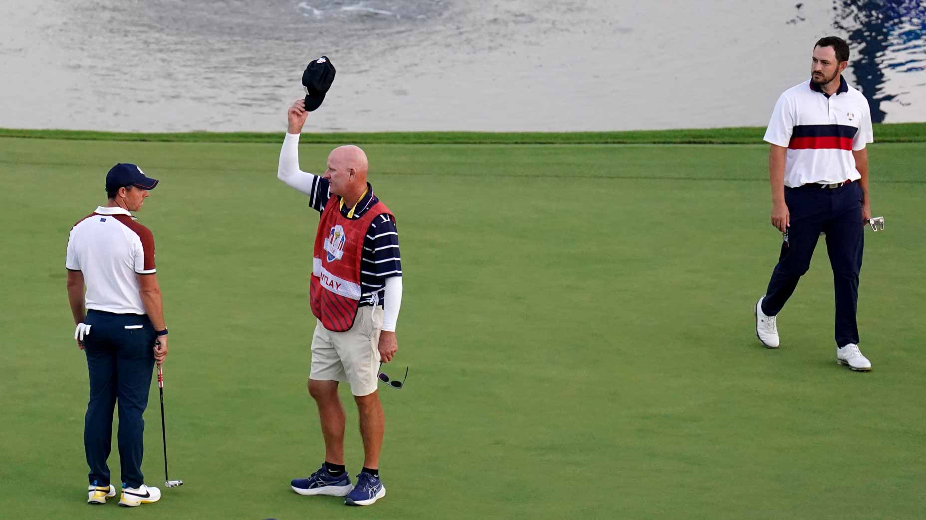 Rory McIlroy, Joe LaCava and Patrick Cantlay on the 18th green at Marco Simone.